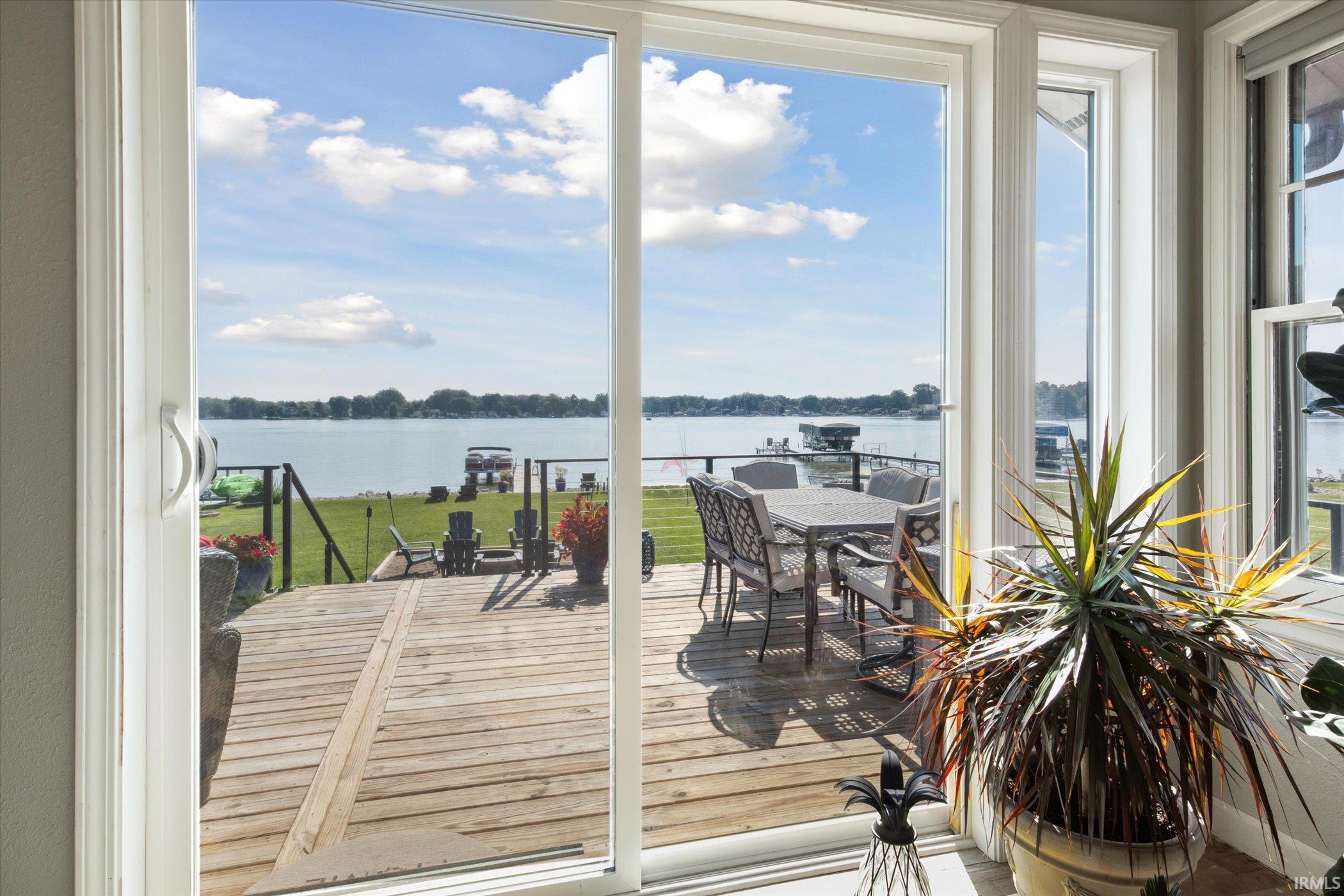 Sunroom with a water view and healthy amount of natural light