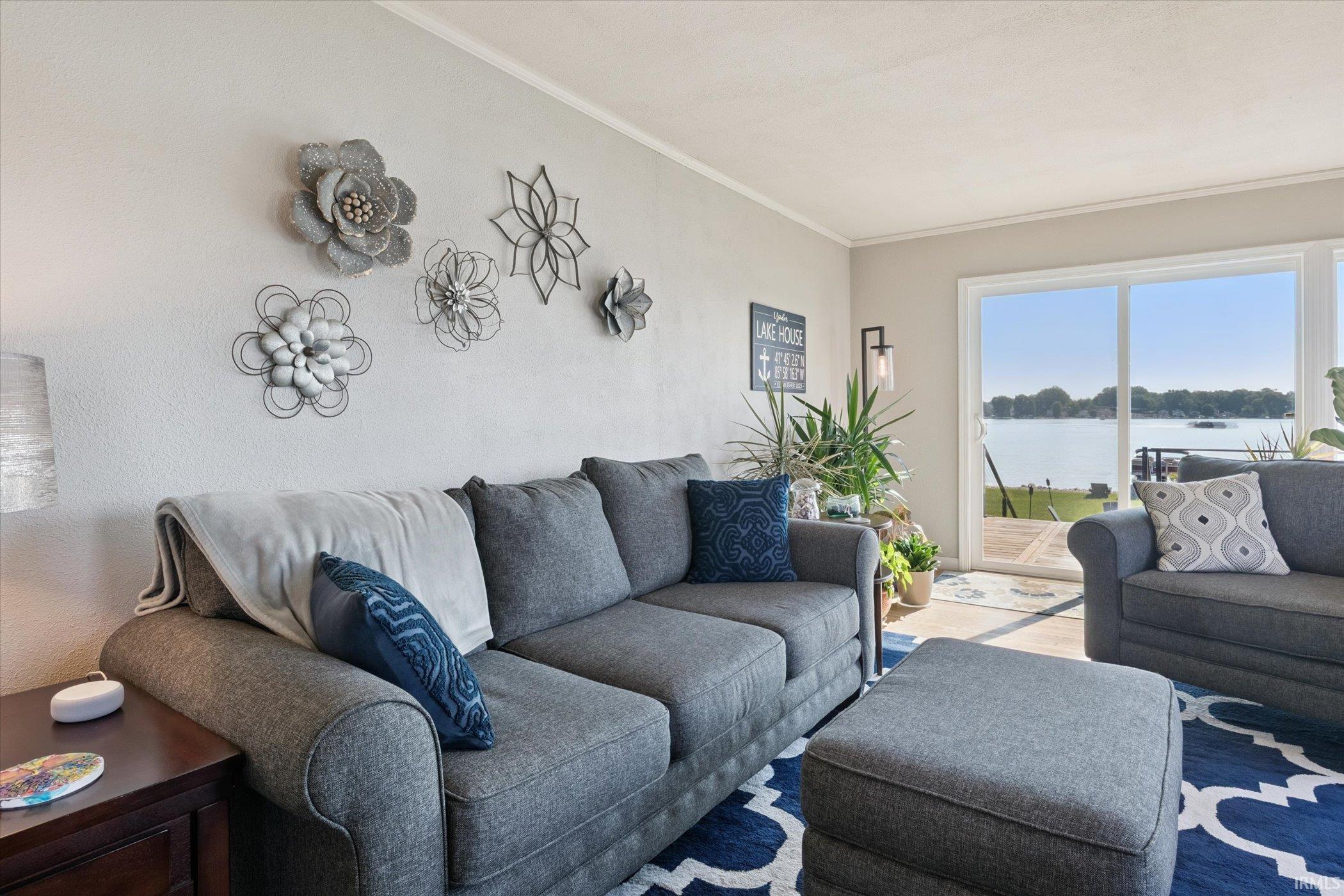 Living room featuring a water view and ornamental molding