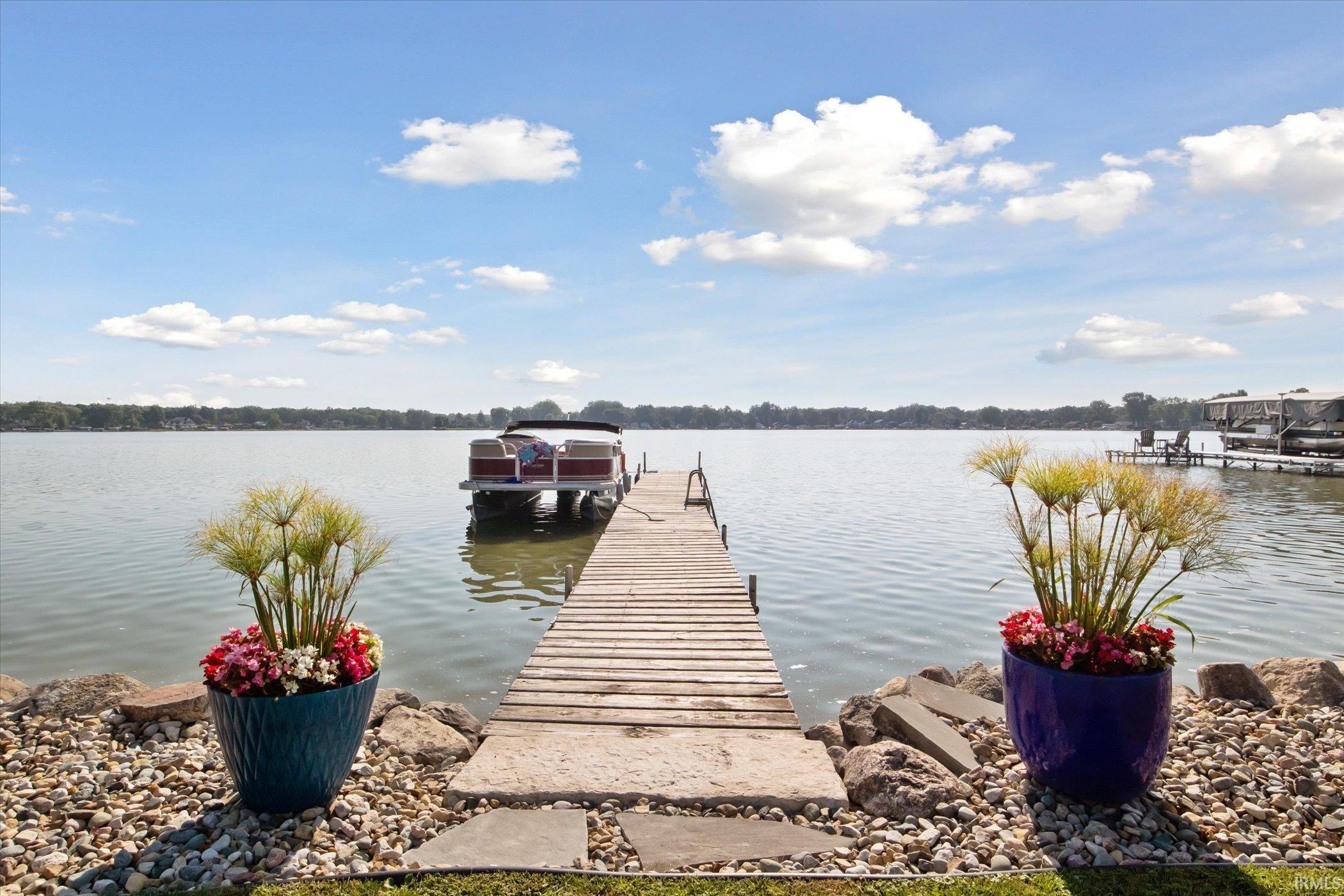 Dock with boat lift and a water view