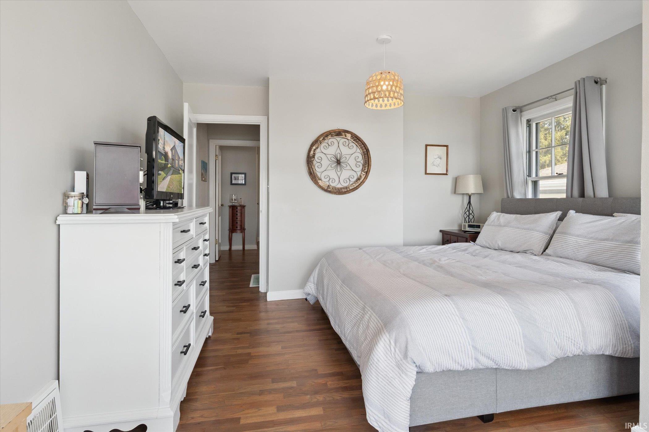 Bedroom with dark wood-type flooring