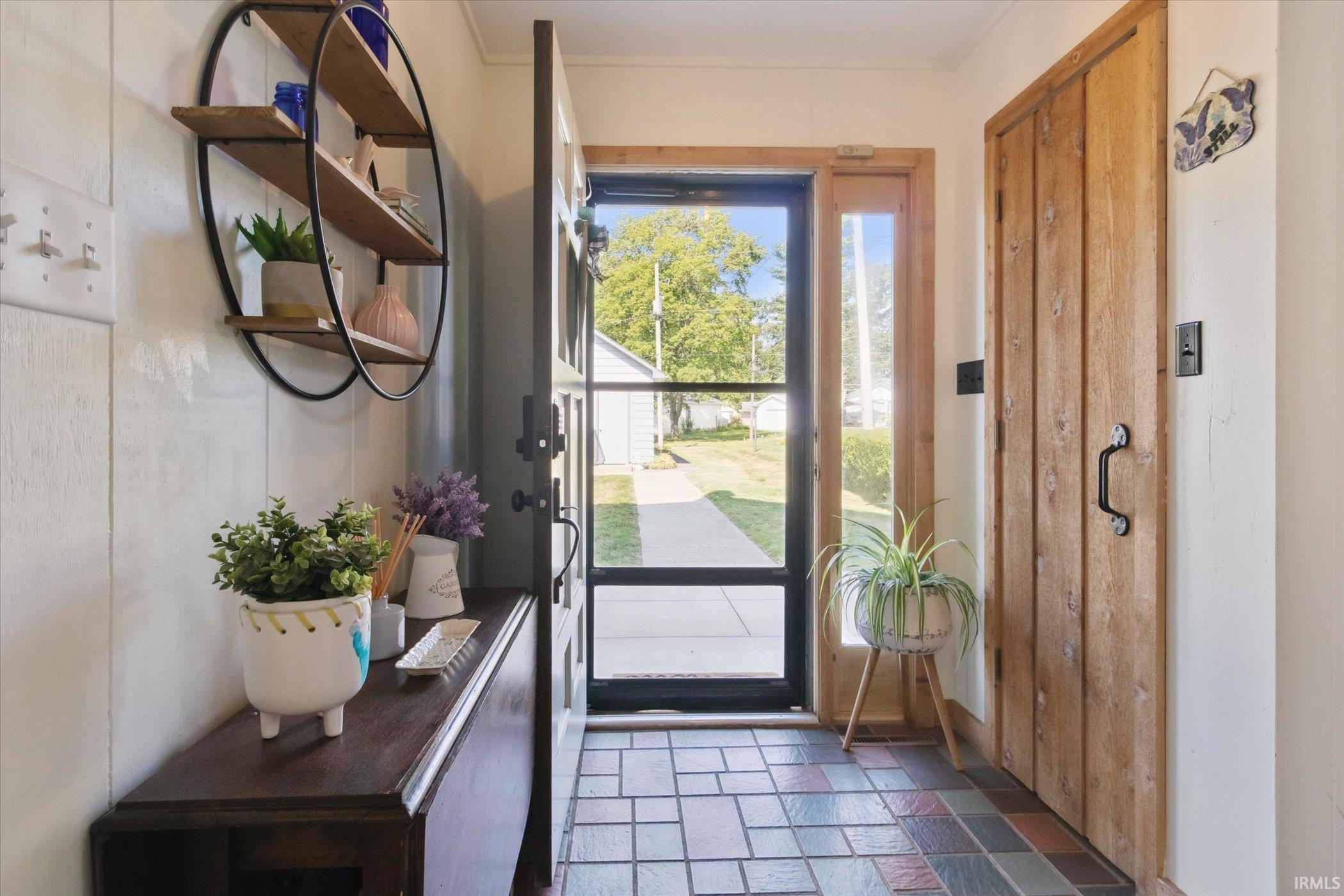Doorway to outside with stone tile flooring