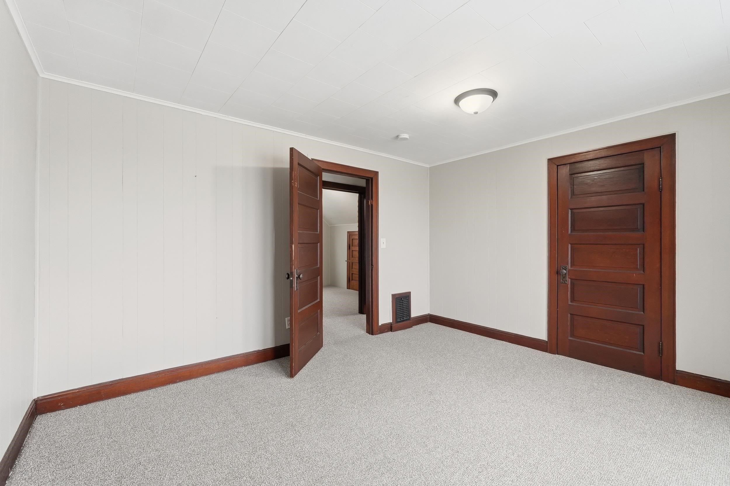 Carpeted empty room with ornamental molding
