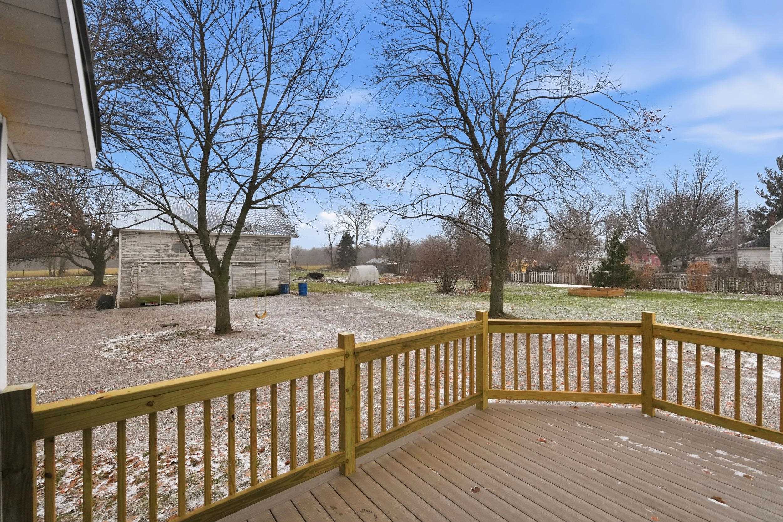 Deck featuring an outdoor structure and a yard