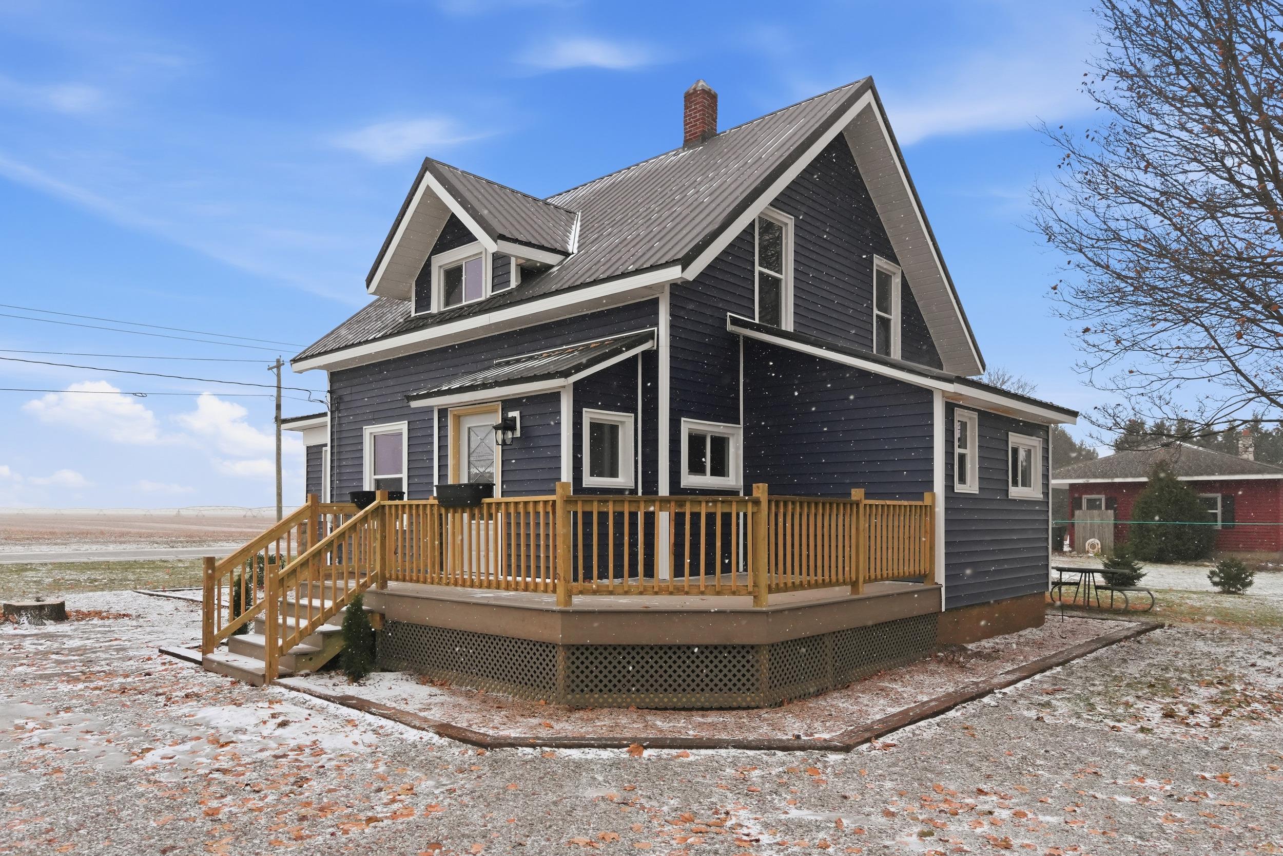 View of front of property featuring a deck and a chimney