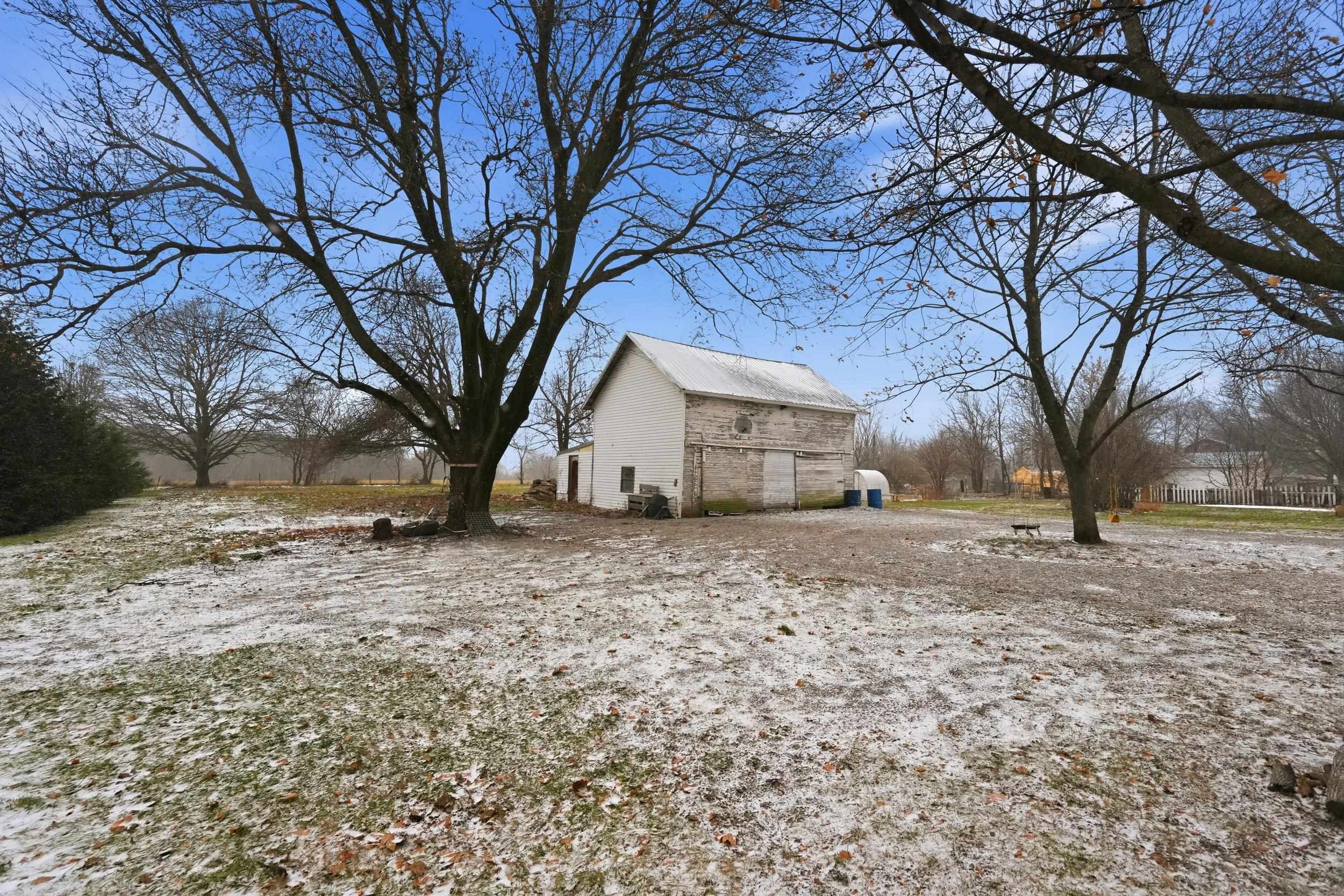 View of yard with an outbuilding and a barn