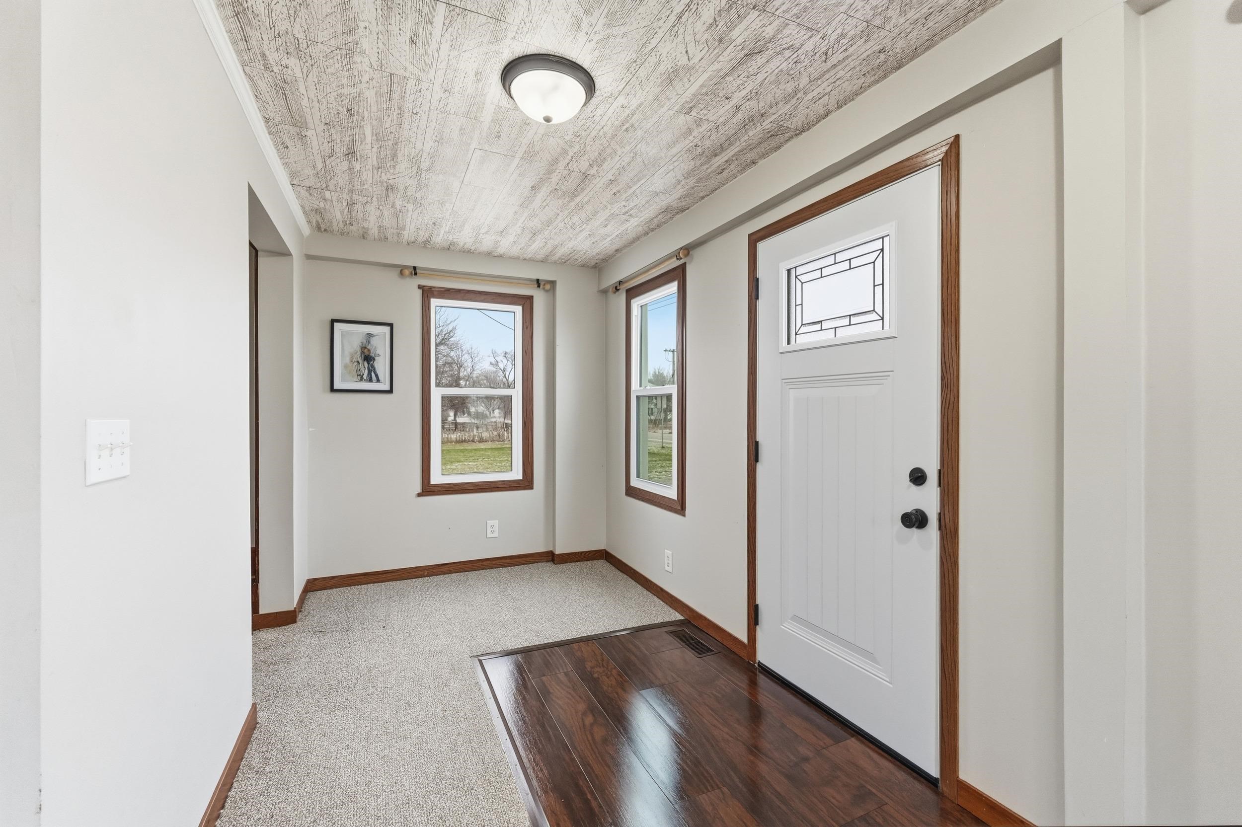 Foyer featuring baseboards and wood finished floors