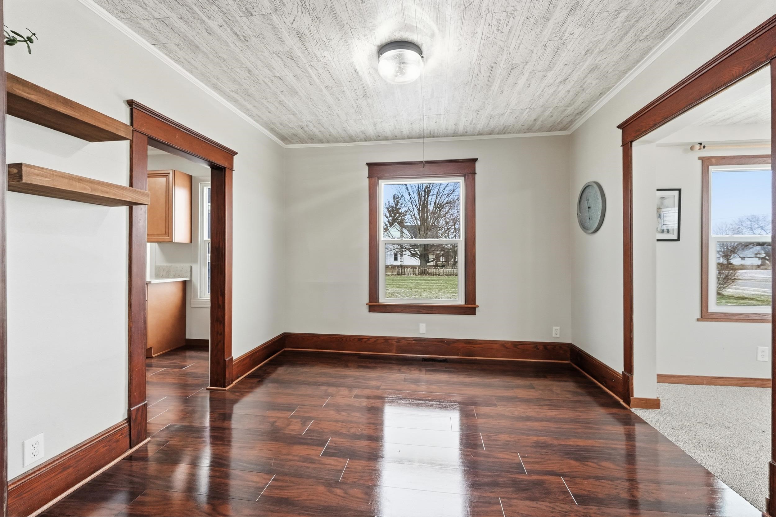 Empty room with wood finish floors and crown molding