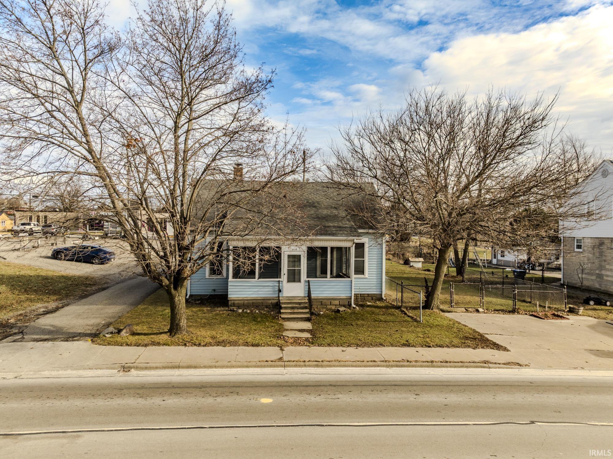 View of front of home with entry steps and roof with shingles