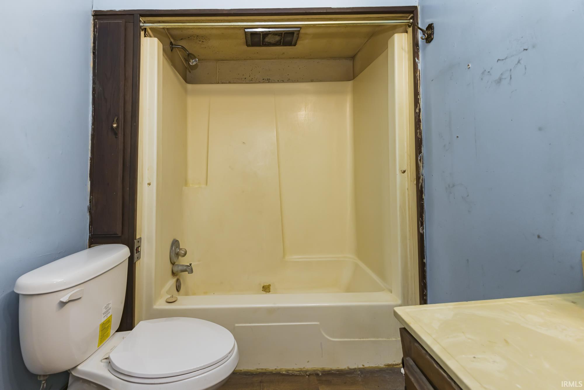 Bathroom with vanity and tub / shower combination