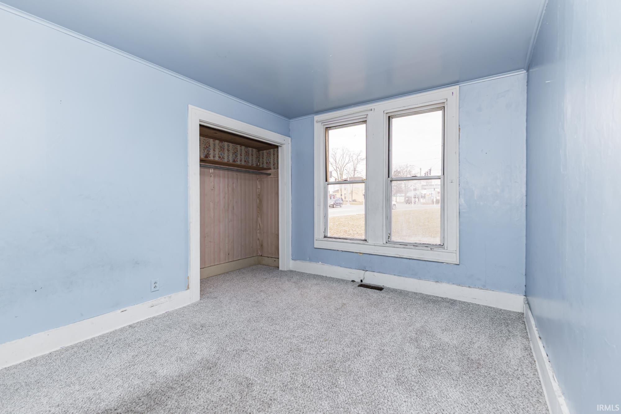 Unfurnished bedroom with a closet and carpet flooring