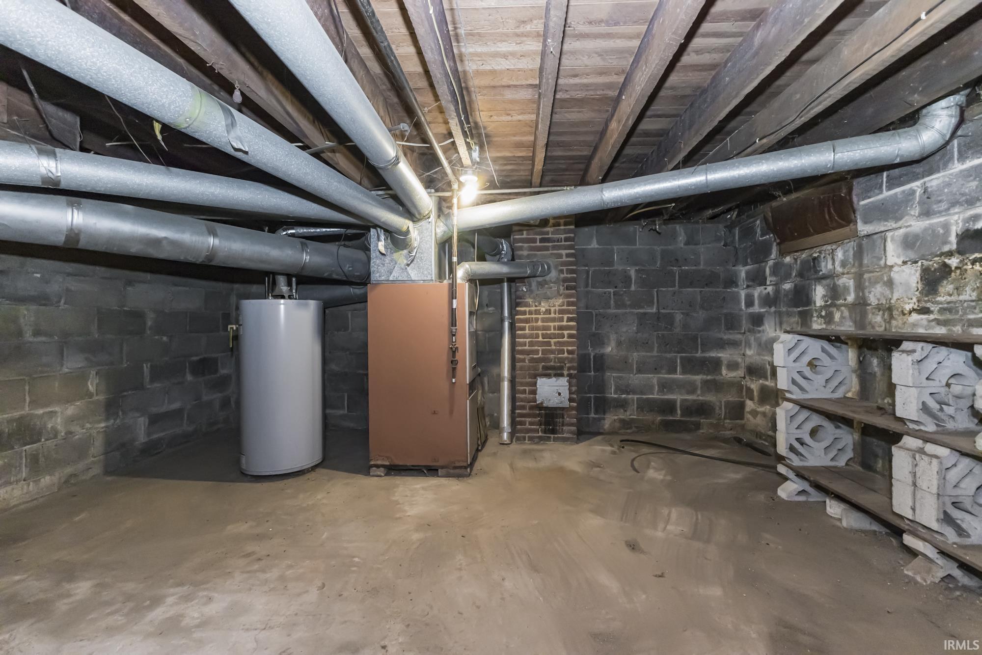 Unfinished basement with water heater and heating unit