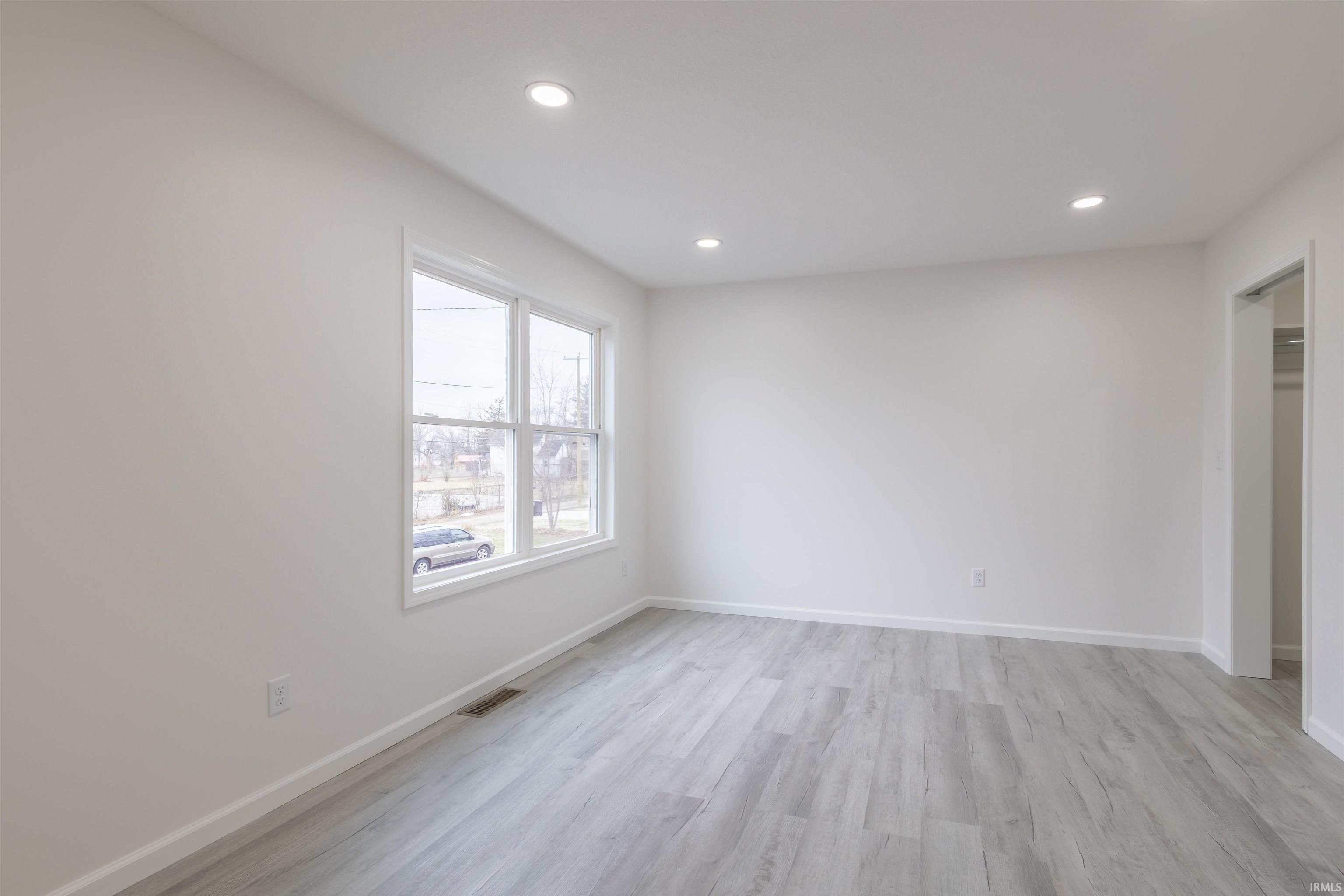 Spare room with light wood-style flooring and recessed lighting