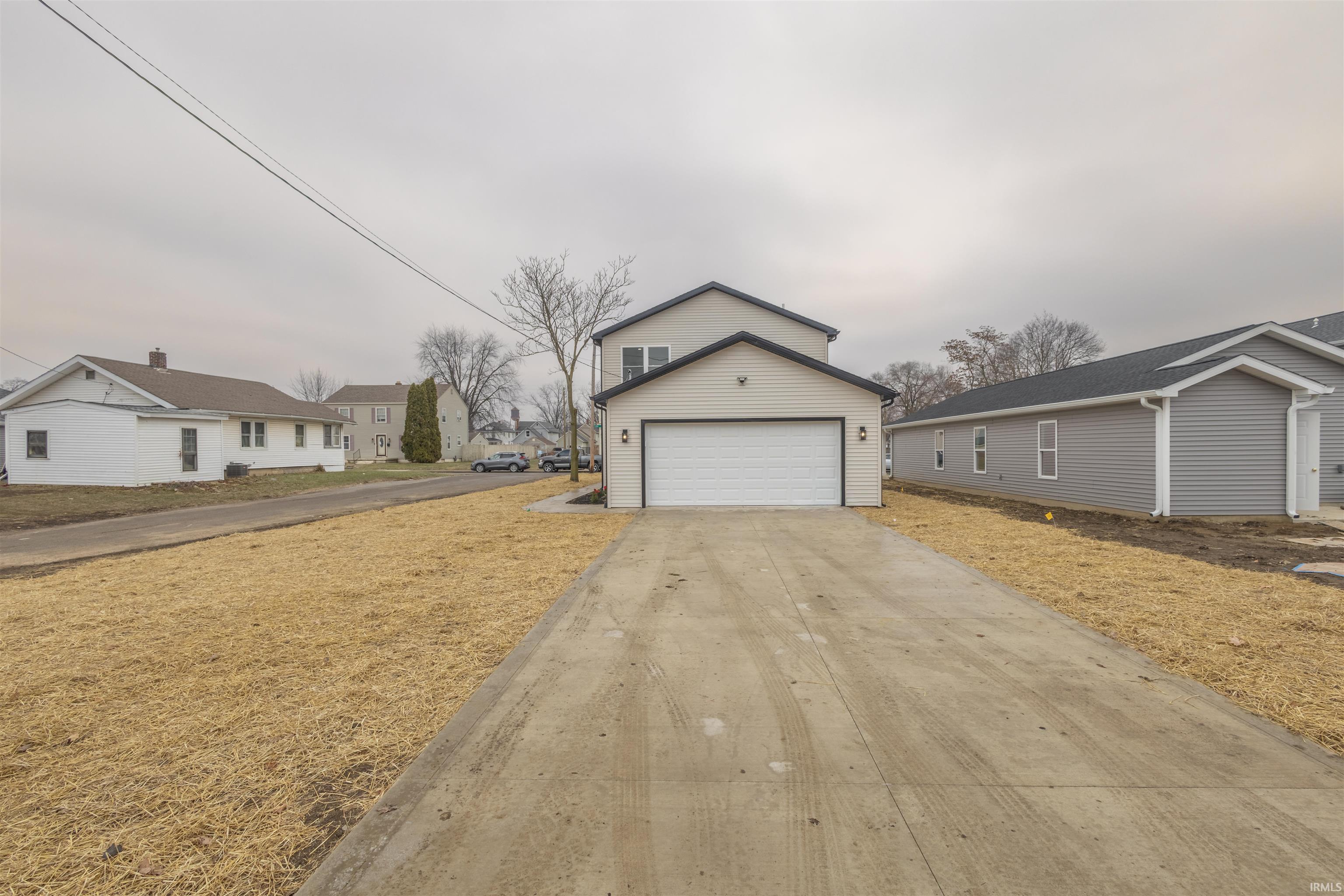 View of front facade with driveway and a garage