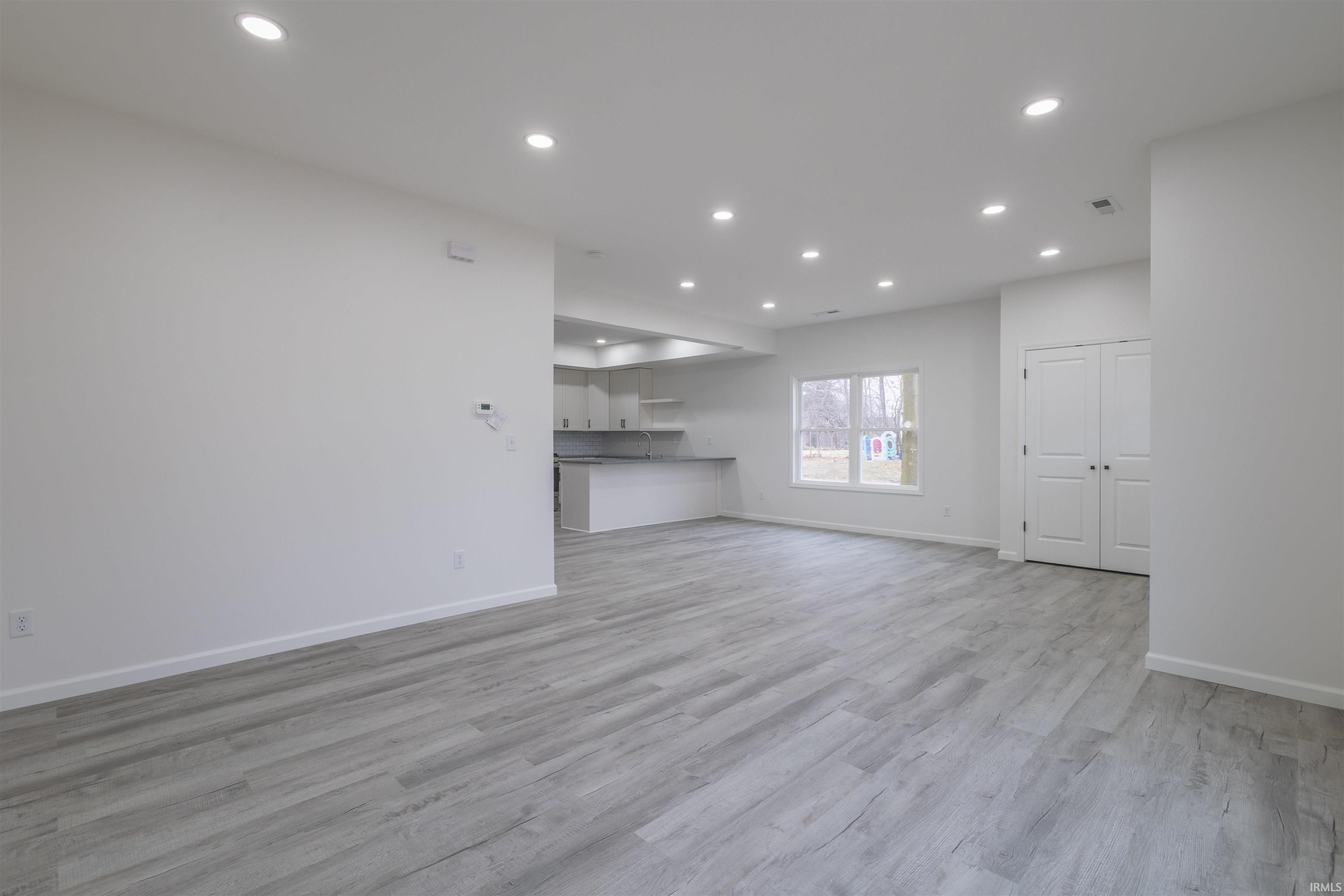 Unfurnished living room with recessed lighting and light wood finished floors