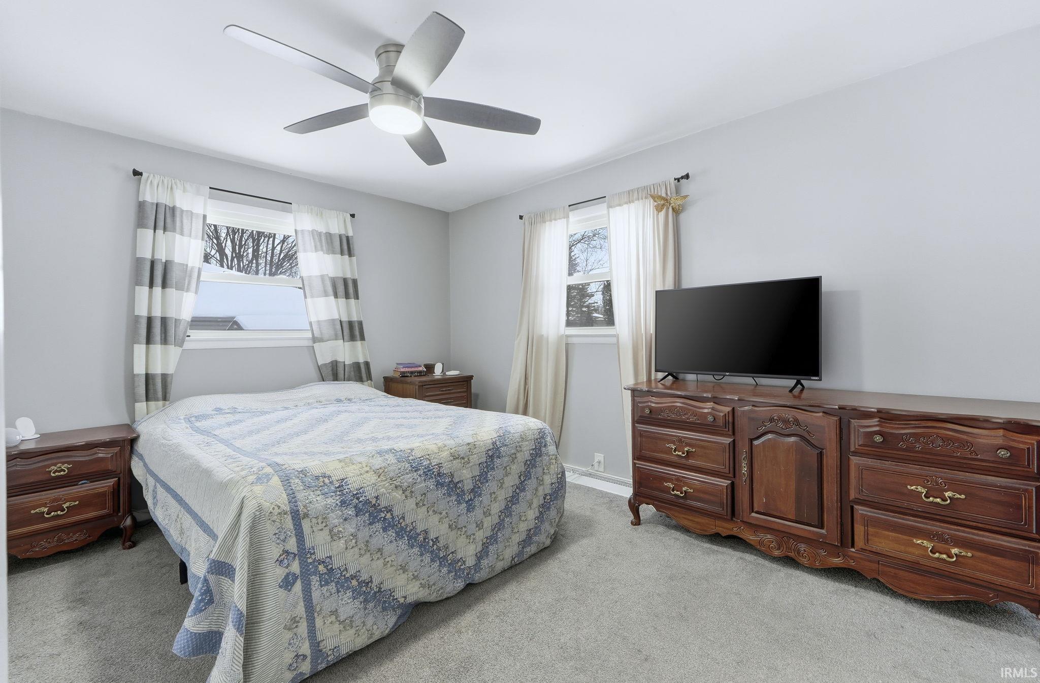 Bedroom featuring light carpet and a ceiling fan