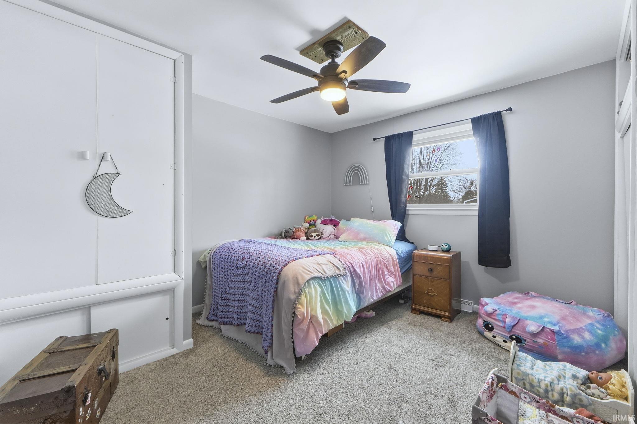 Bedroom with carpet flooring and a ceiling fan