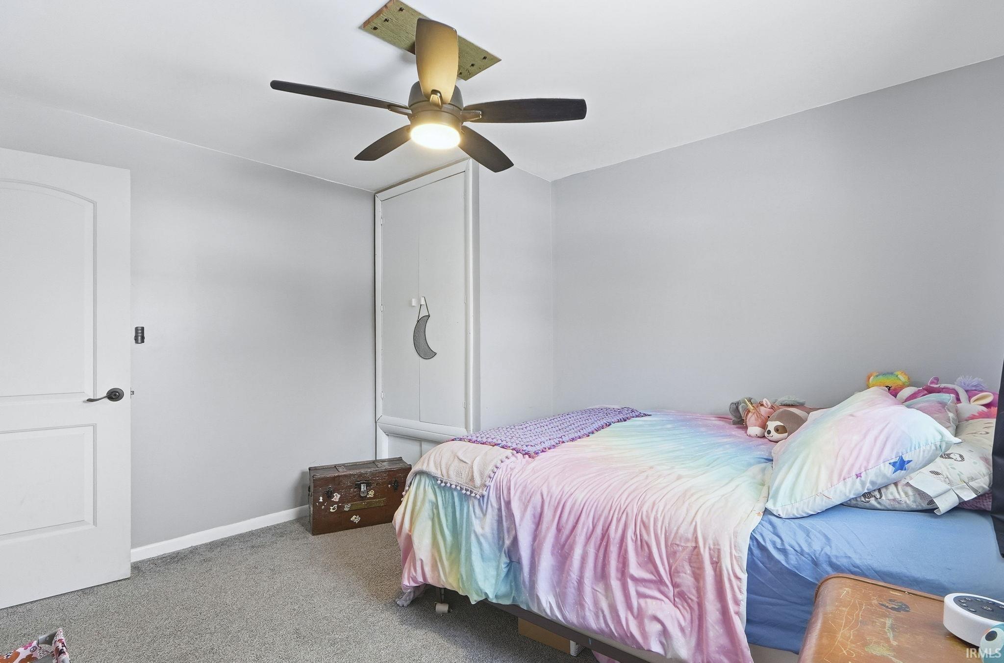 Bedroom with carpet and a ceiling fan