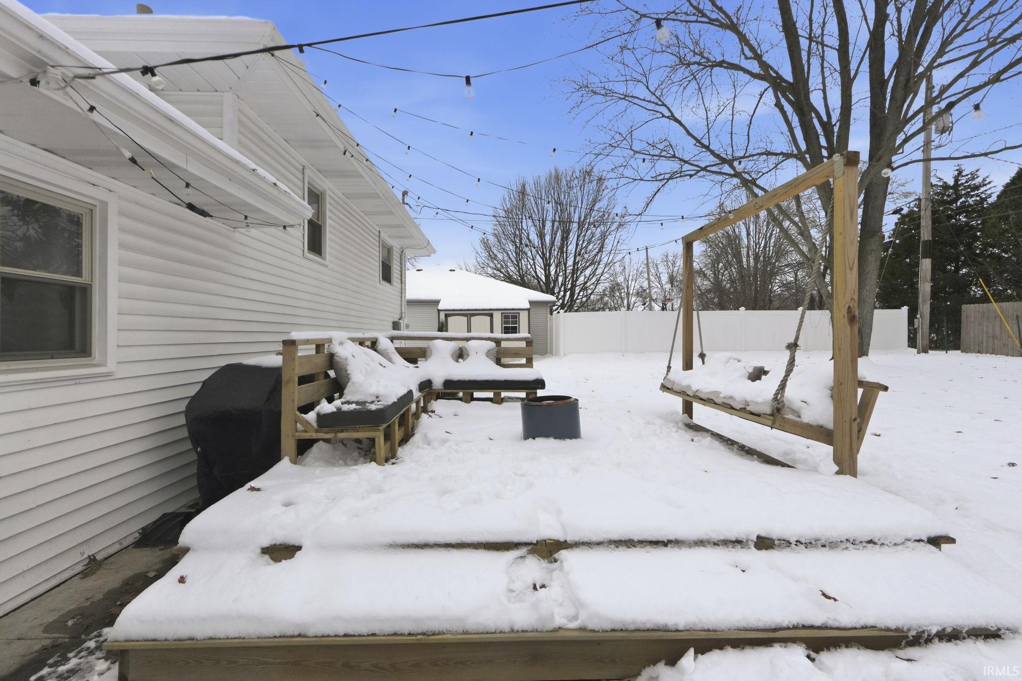 Snow covered deck with grilling area