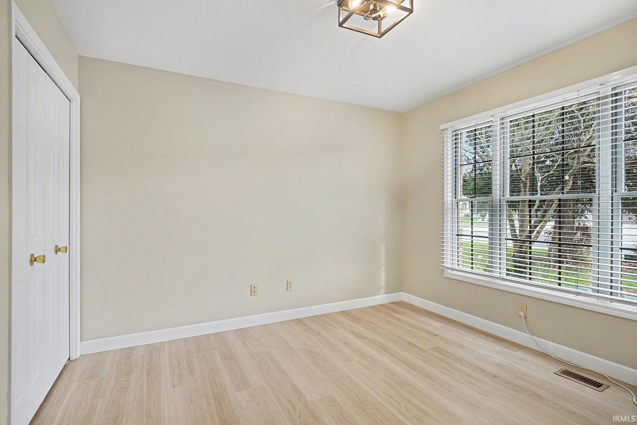 Unfurnished bedroom with light wood-type flooring and a closet