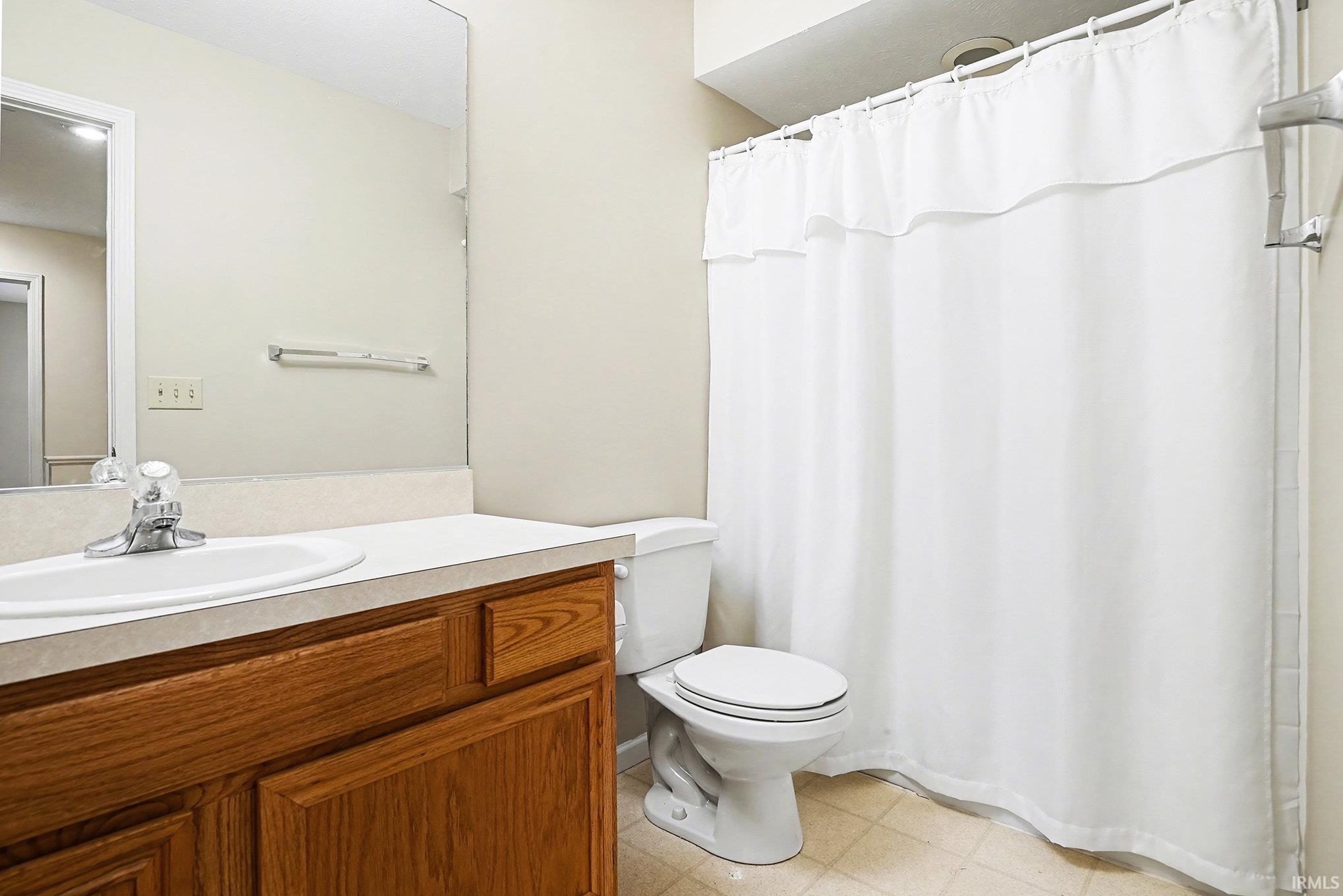 Full bathroom with a shower with curtain and vanity