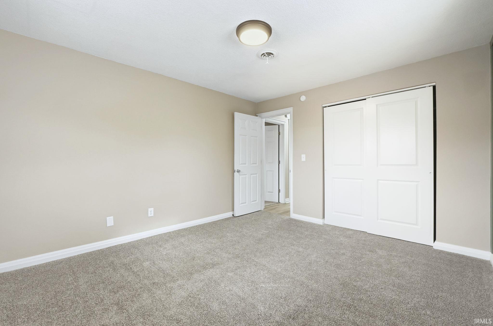 Unfurnished bedroom with a closet and carpet