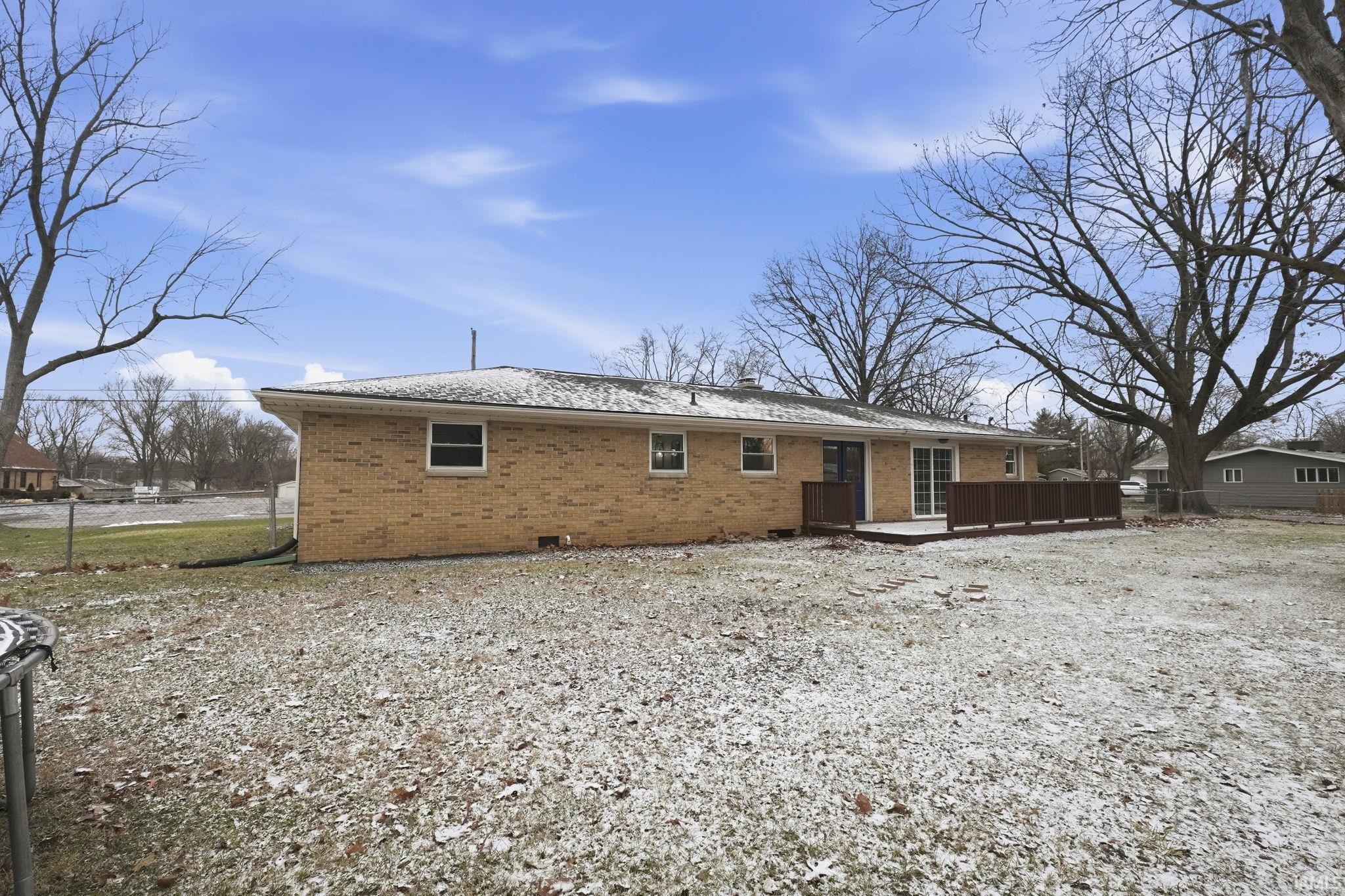 Rear view of property featuring brick siding