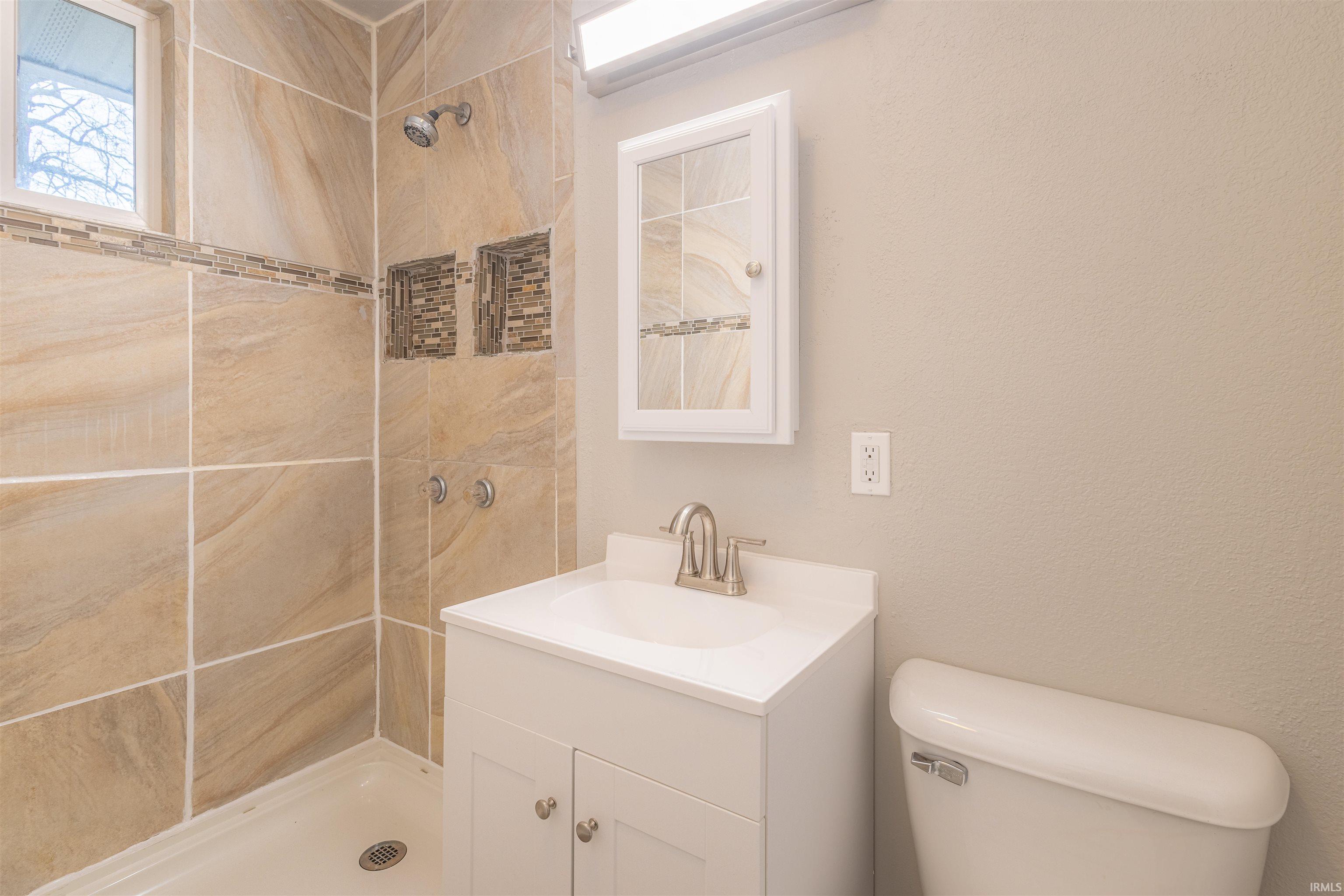 Bathroom with a stall shower and vanity