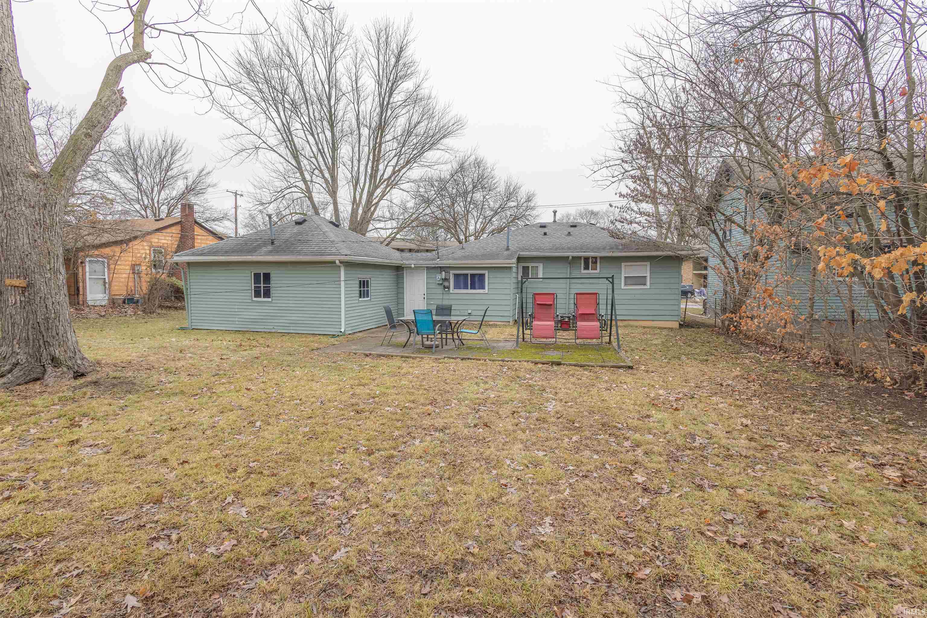 Rear view of house featuring a patio area and a yard