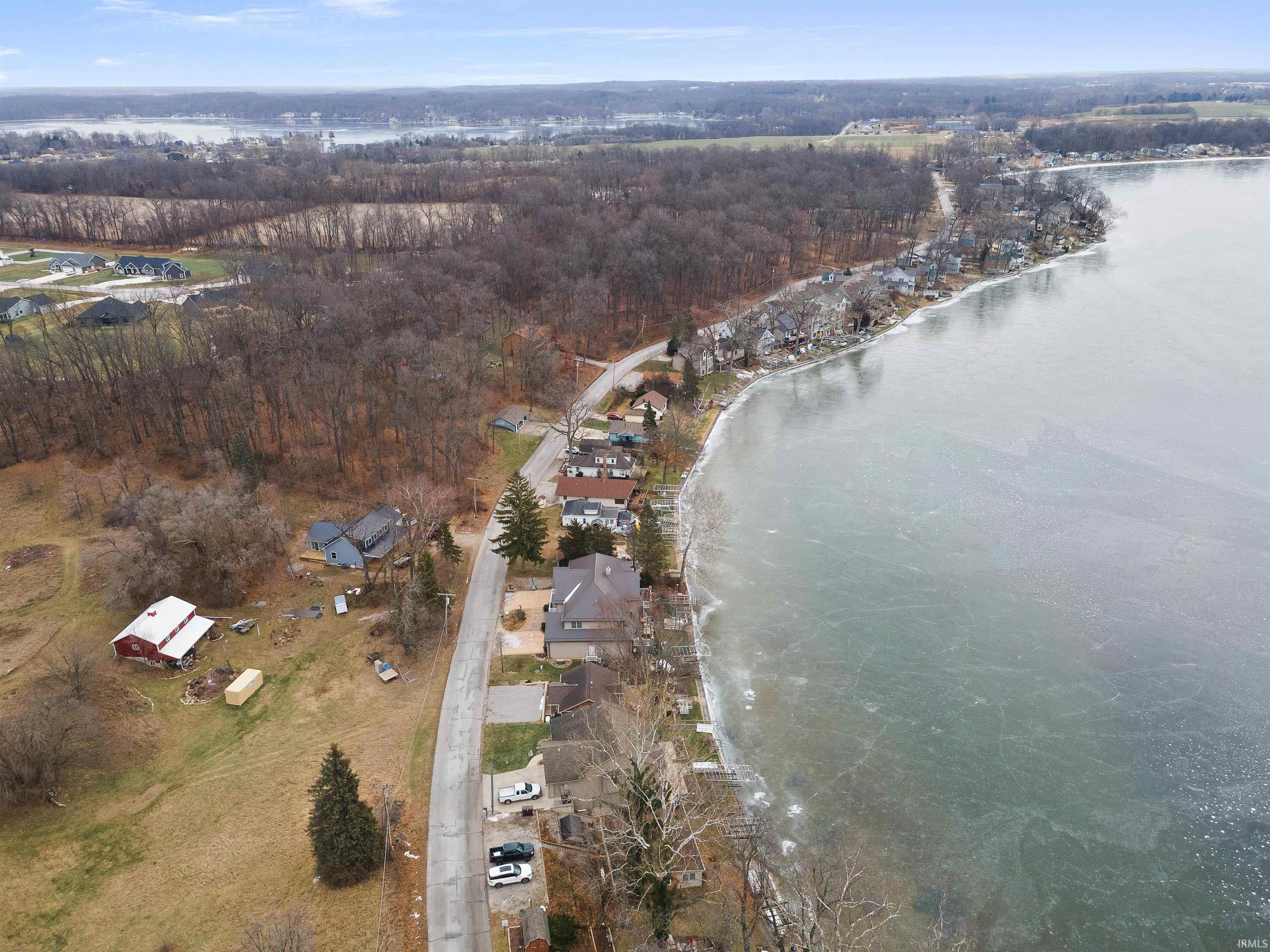 Aerial view of property and surrounding area with a large body of water