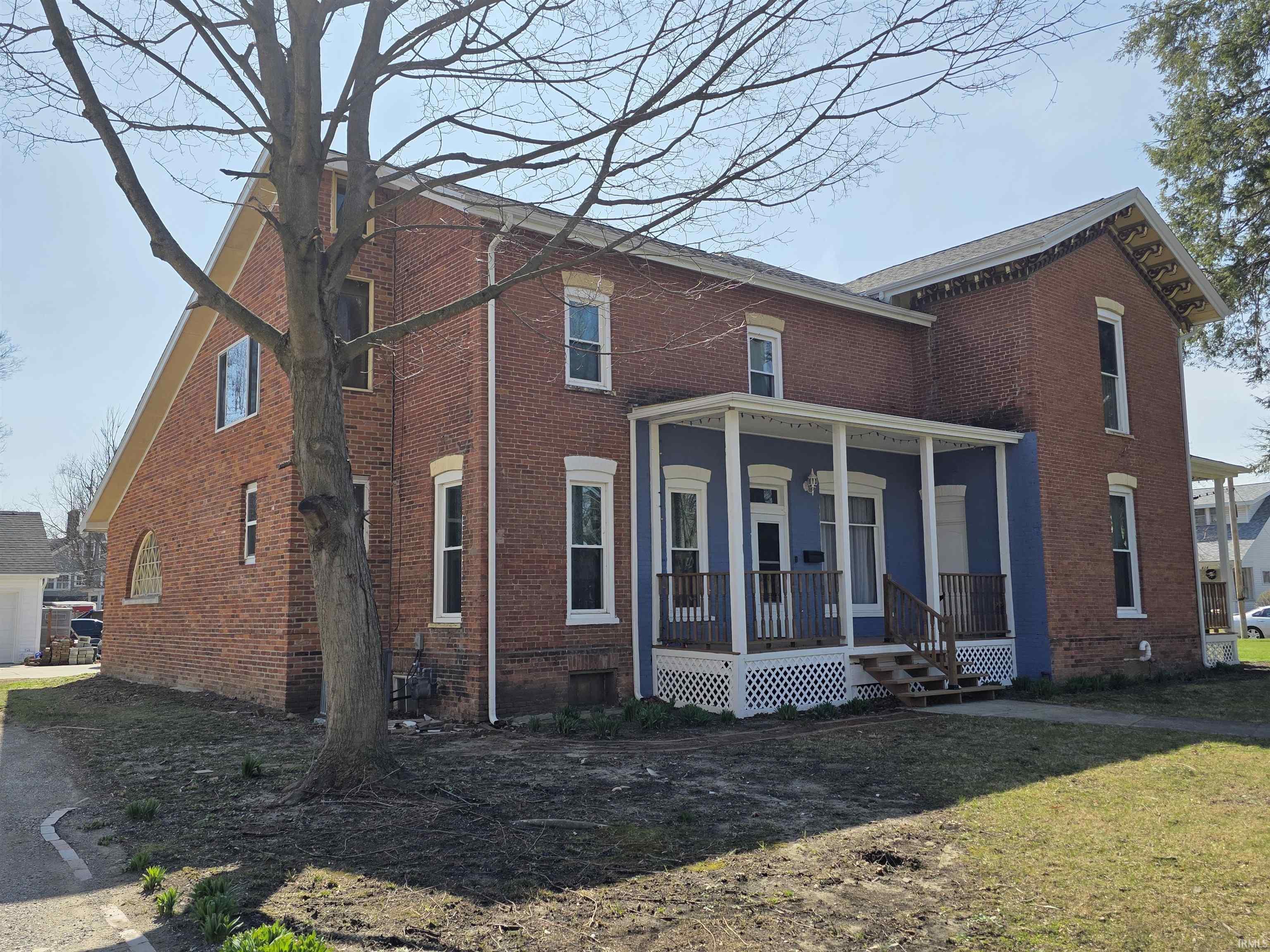 View of front of house with covered porch and brick siding Painting is scheduled when the weather stays warm enough