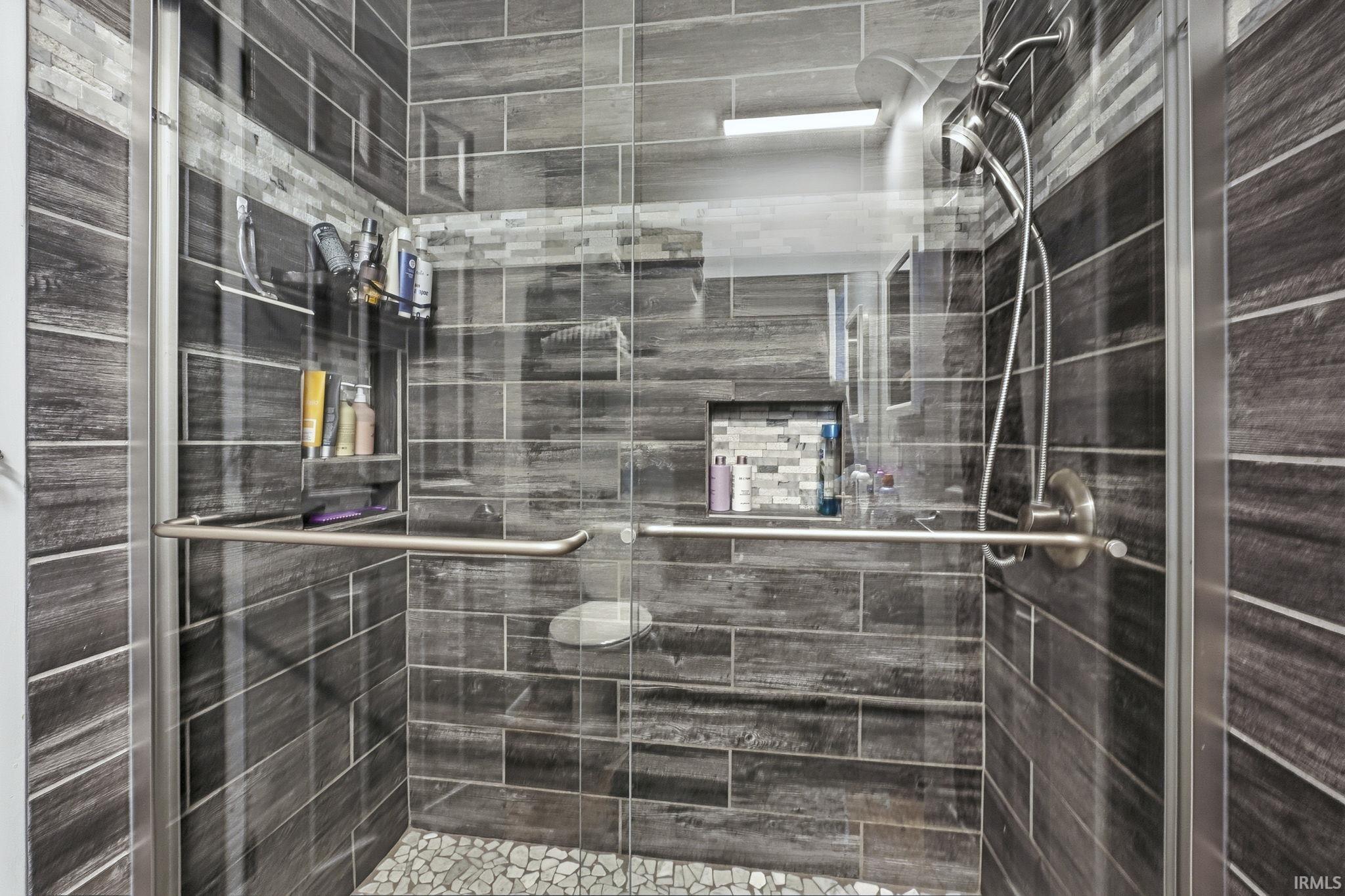 Full bathroom featuring a shower stall