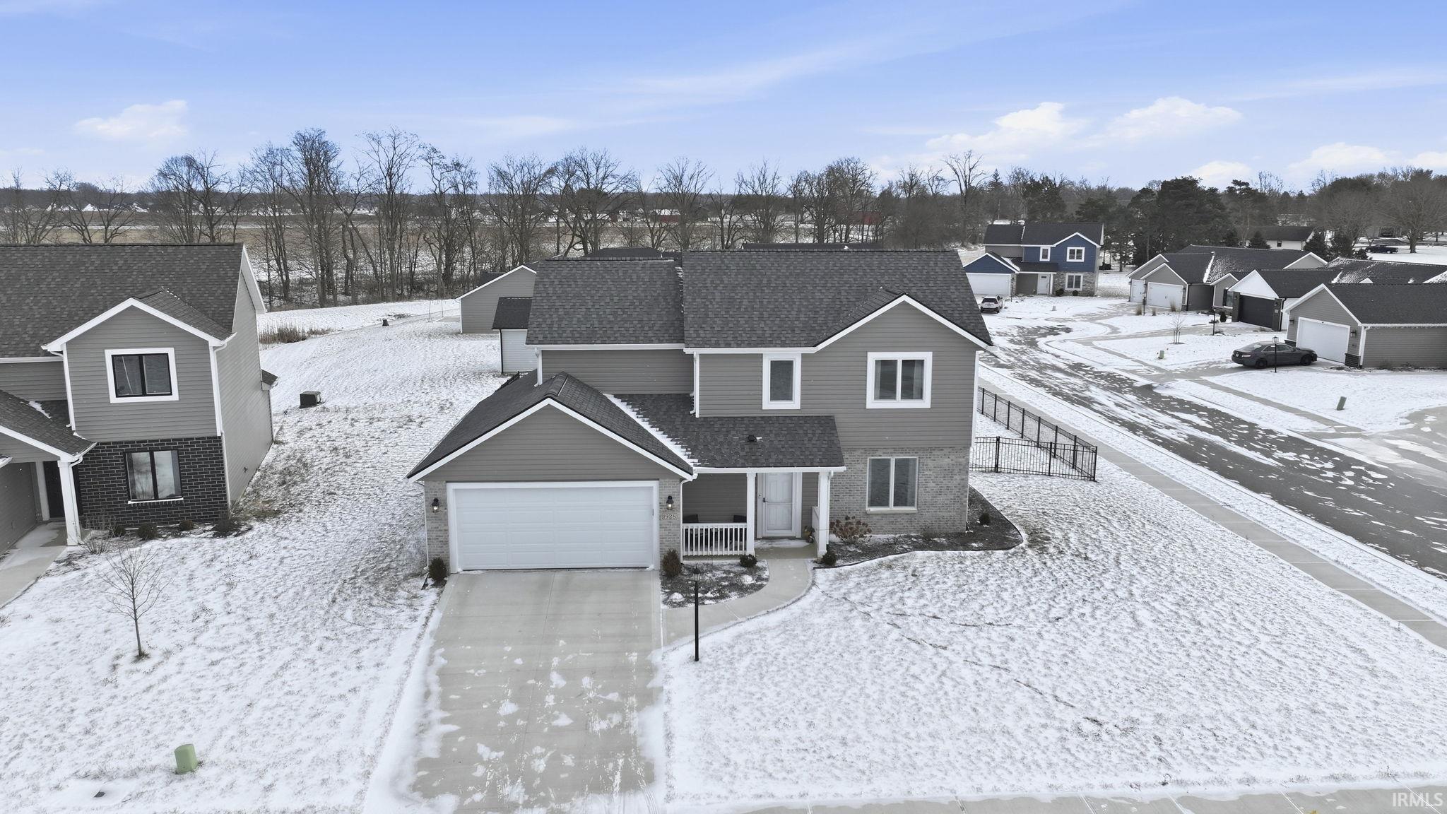 Snowy aerial view with a residential view