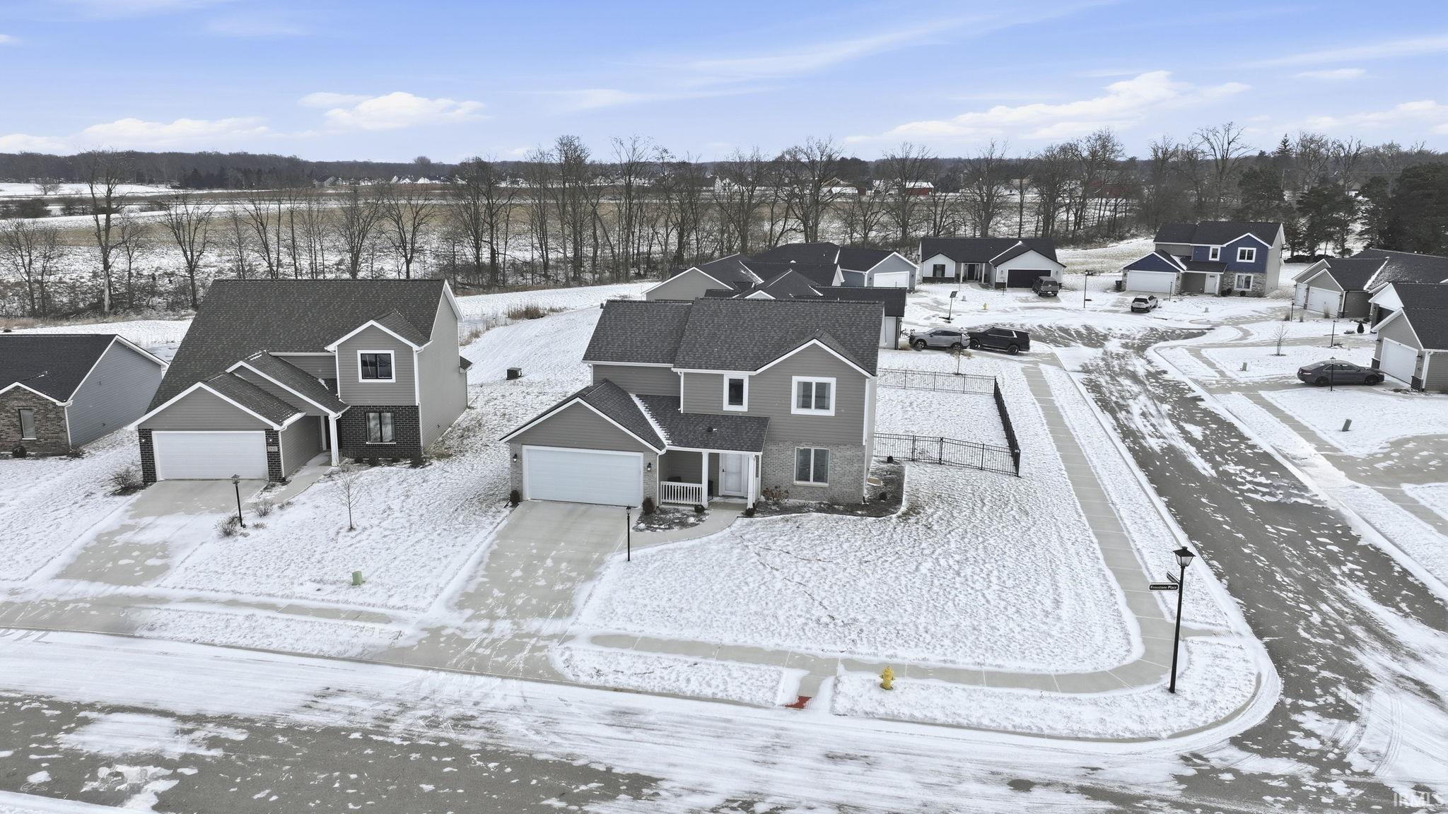 Snowy aerial view with a residential view