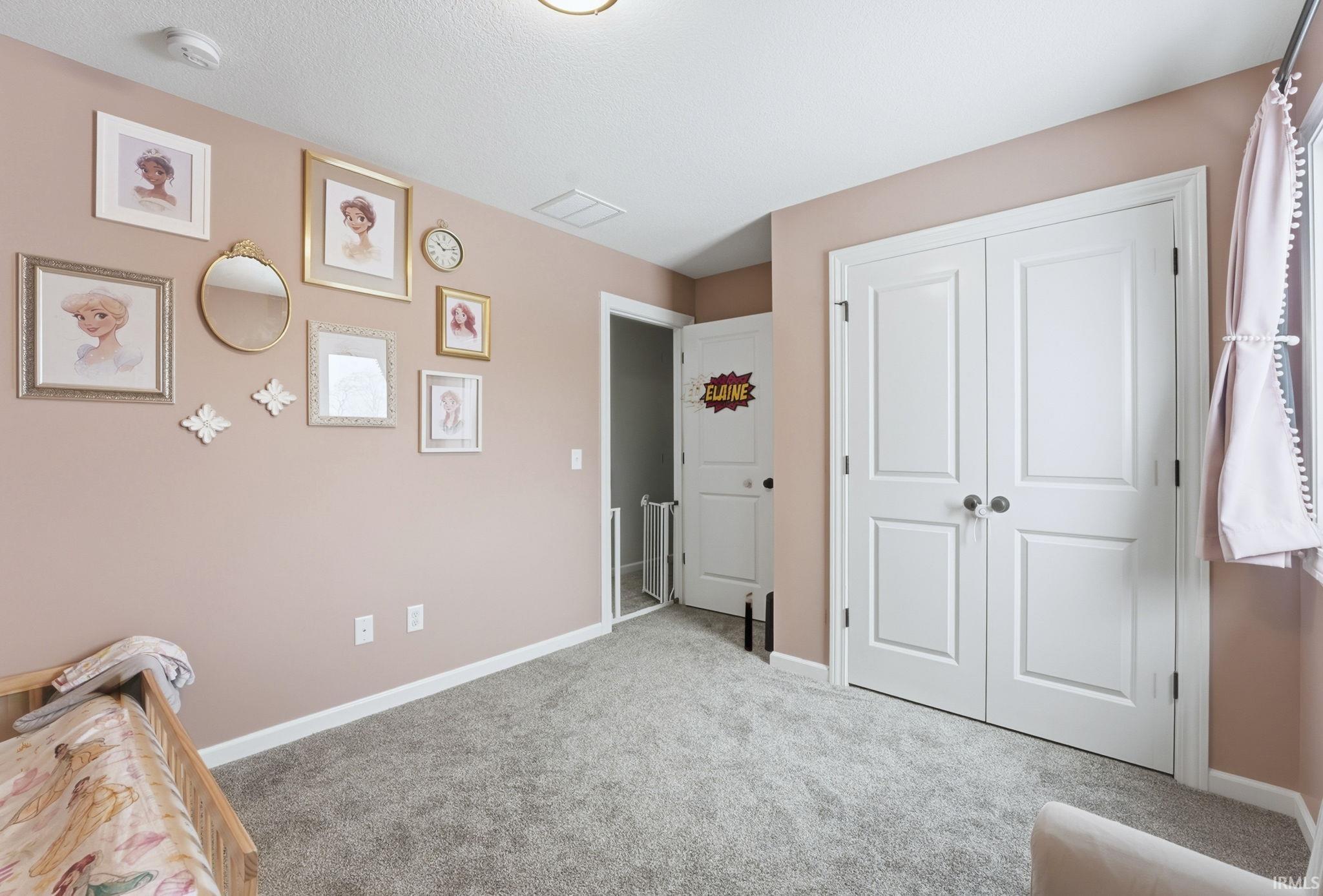 Sitting room featuring carpet and a textured ceiling