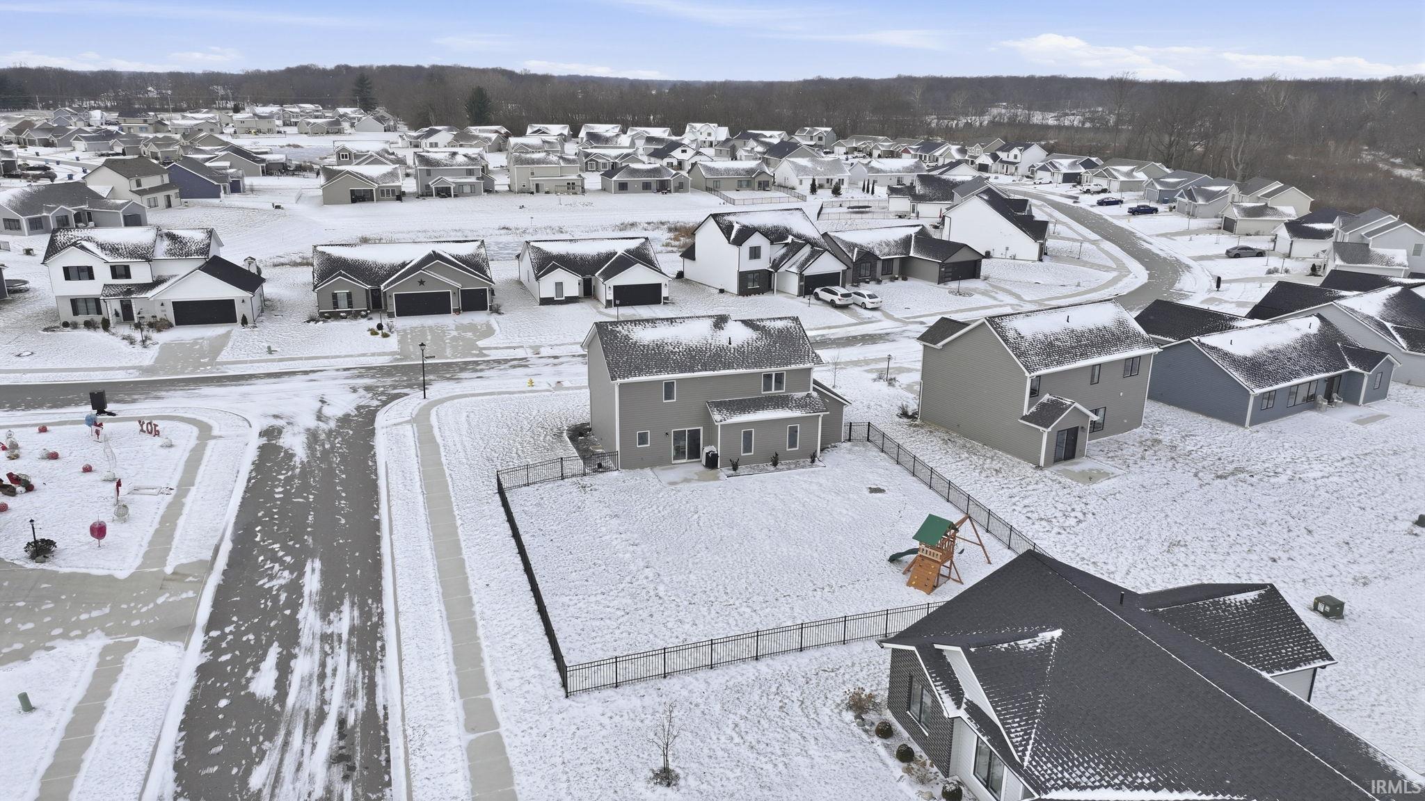 Snowy aerial view featuring a residential view