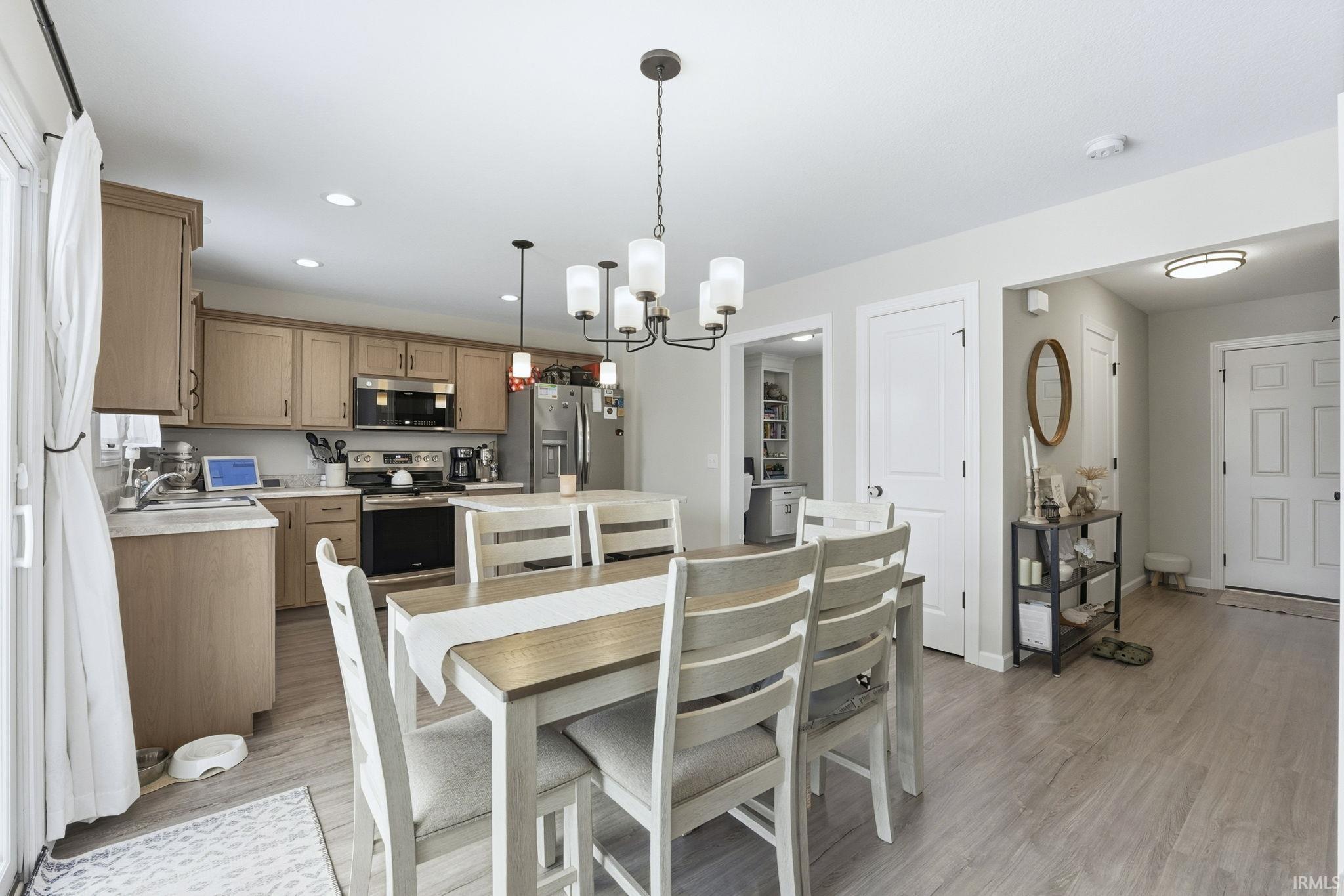 Dining room featuring a chandelier, recessed lighting, and light wood-style flooring