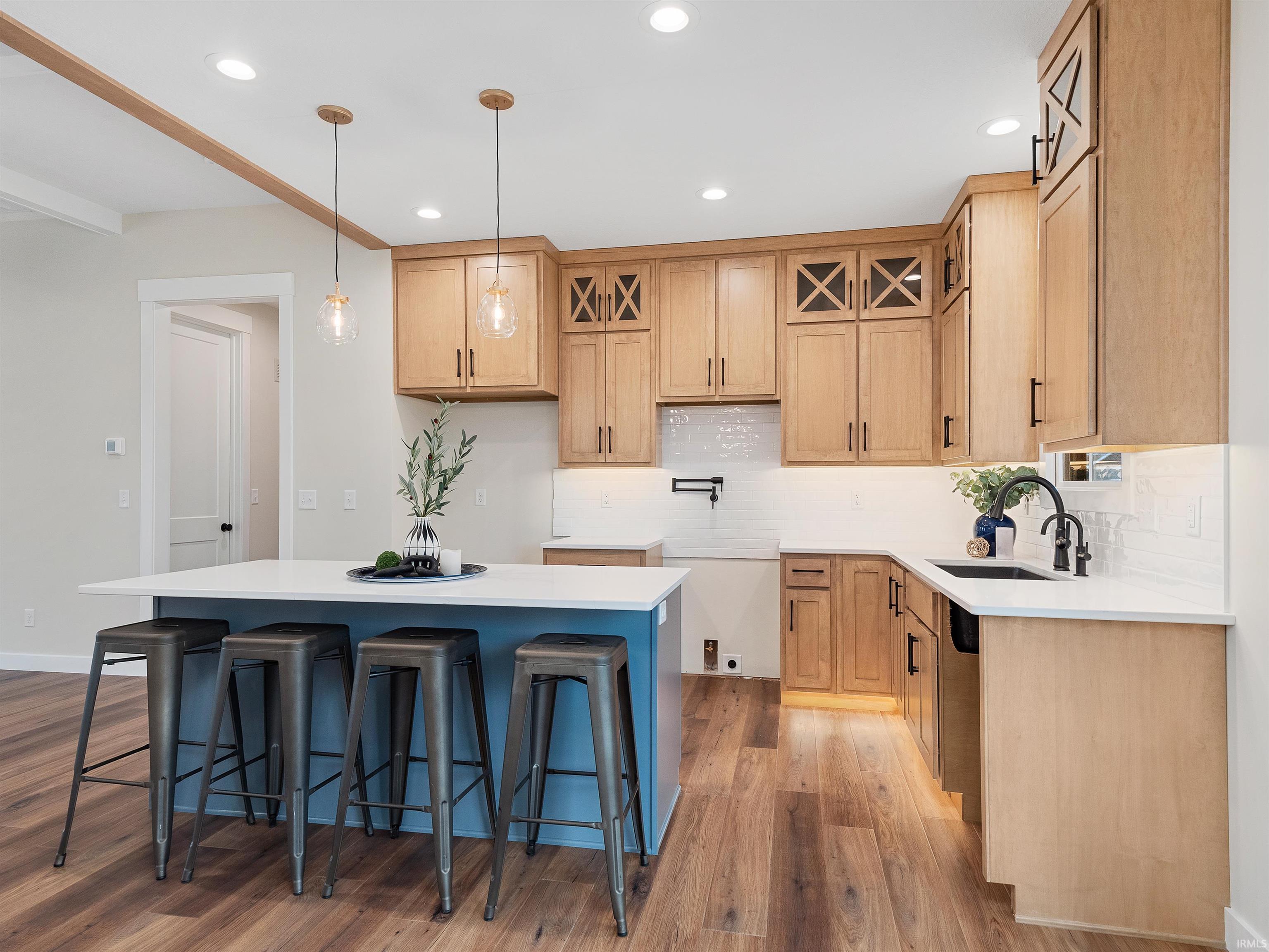 Custom kitchen, soft close cabinets, quartz counters, tile backsplash, wide plank LVP