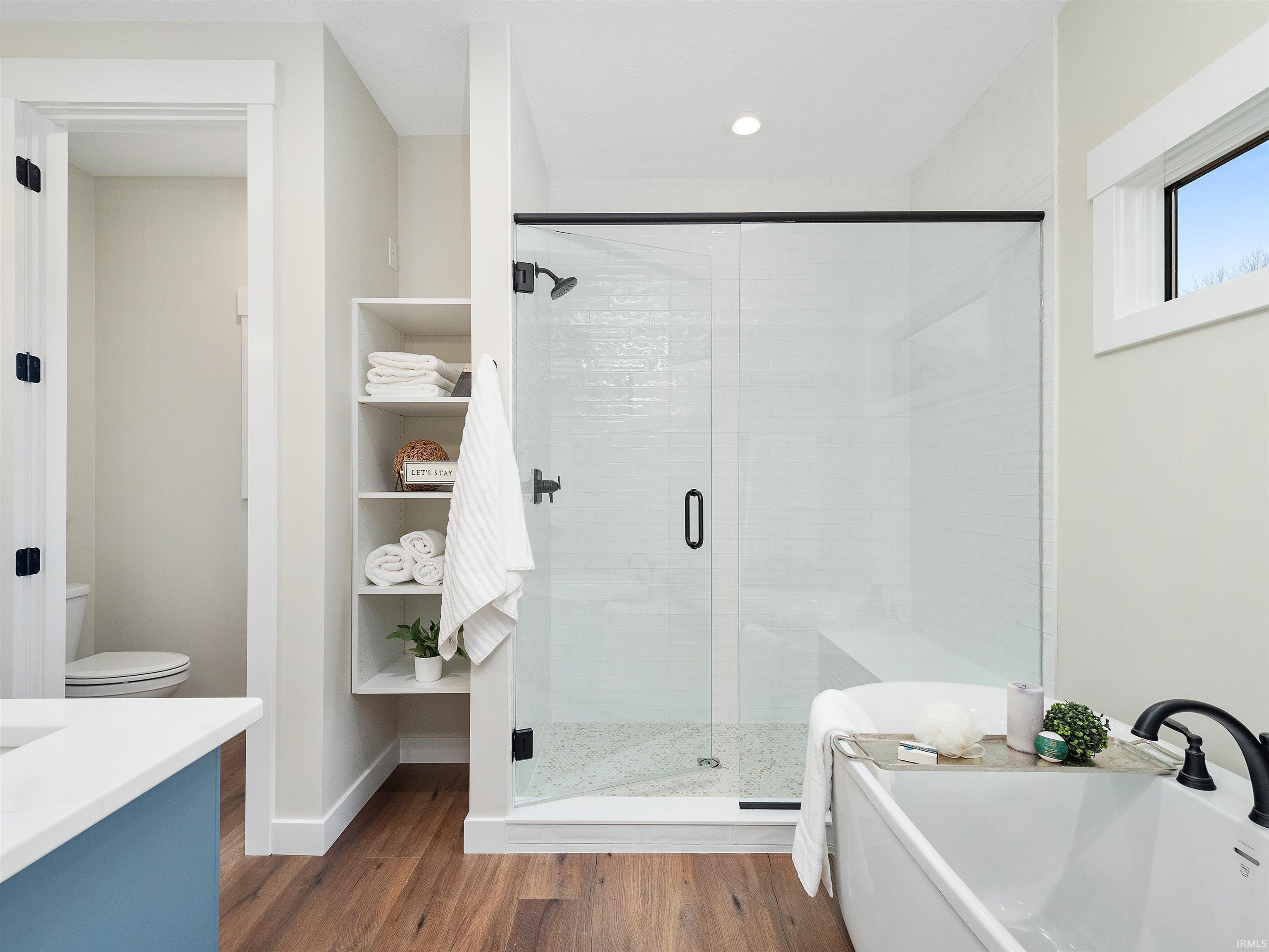 Custom cabinets, quartz, tile, free standing tub, separate walk in shower, natural light, private commode