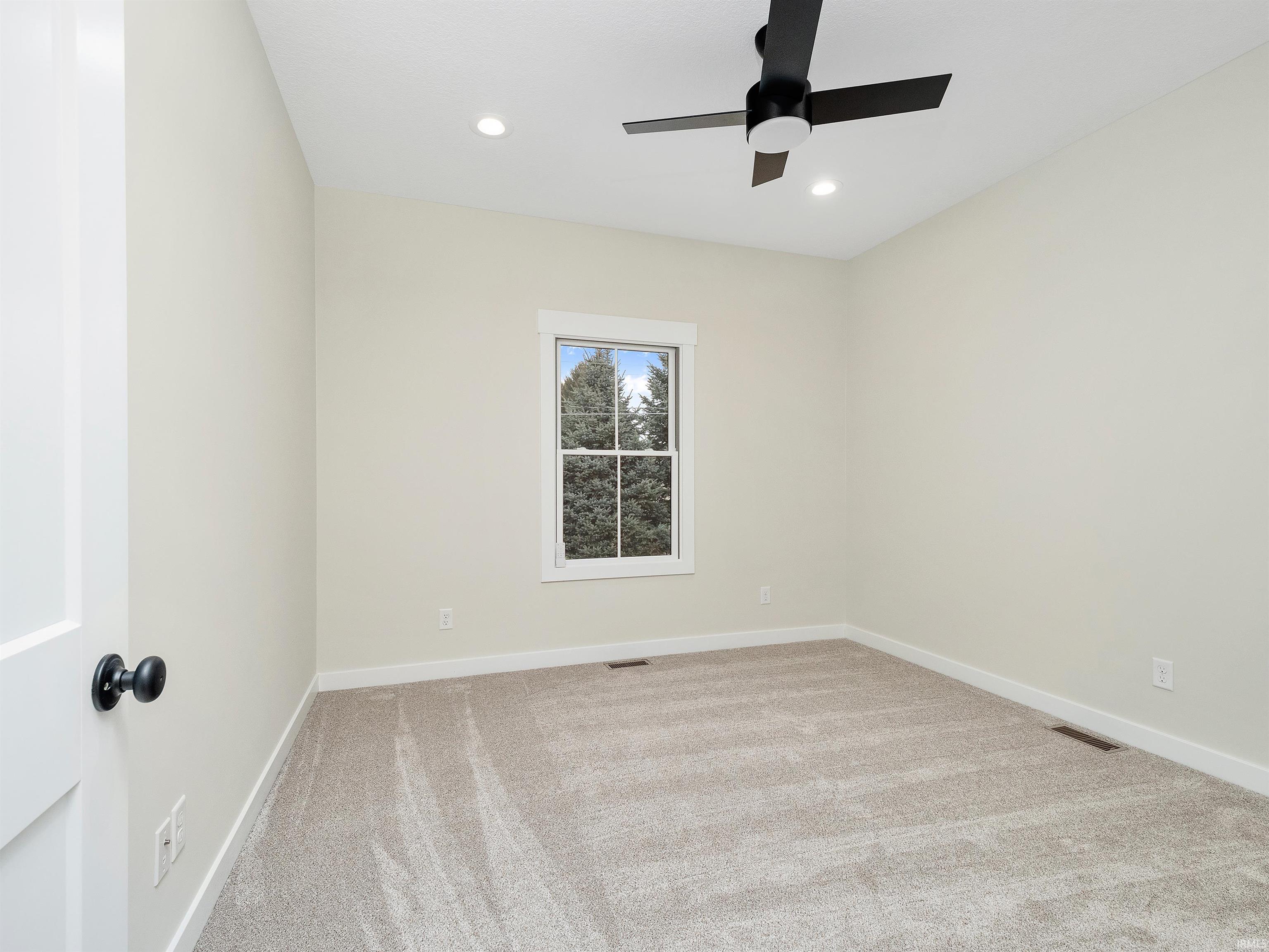 Neutral colors, carpet, 8' interior wood paneled doors, recessed lighting, and ceiling fan