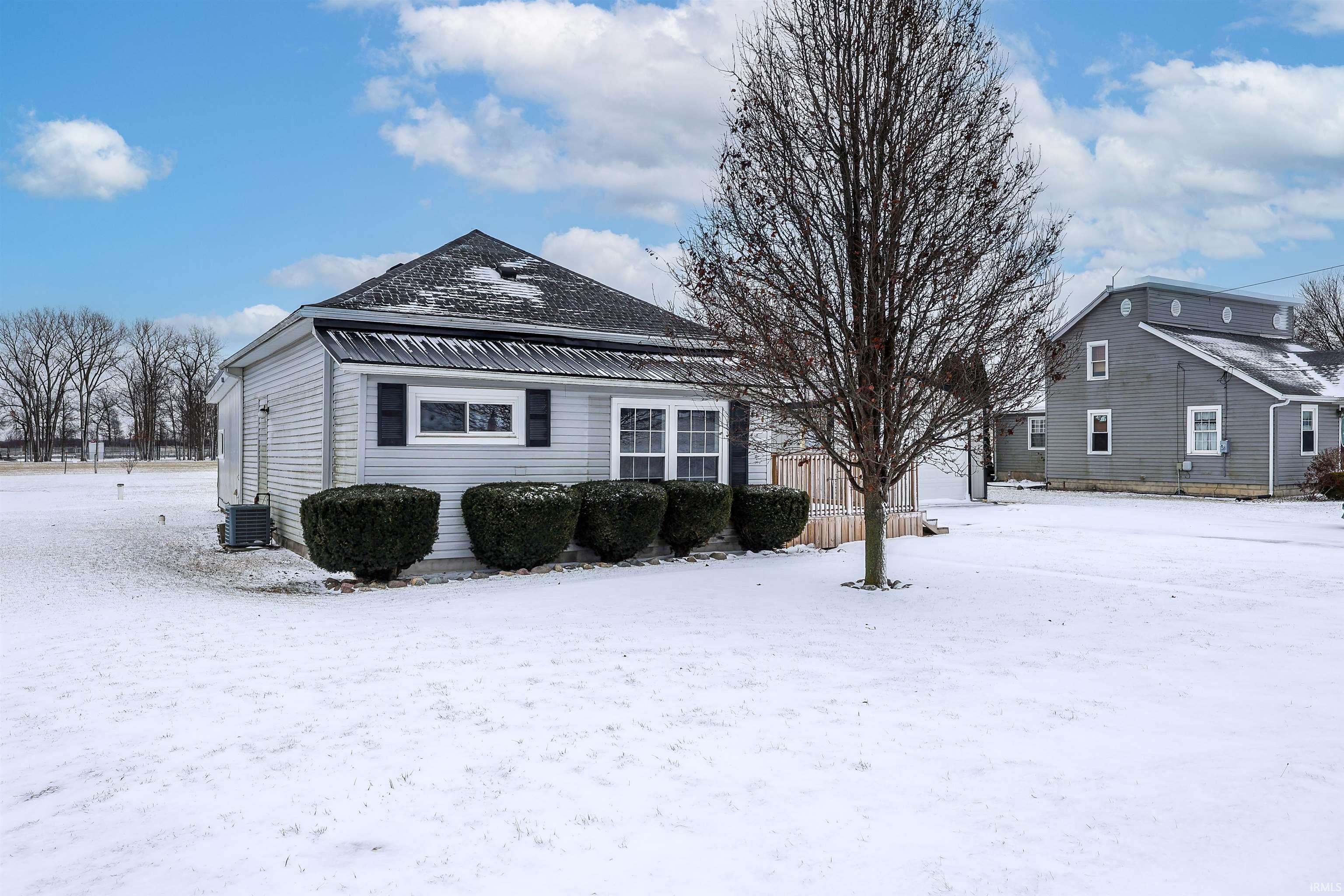 View of snowy exterior featuring a central air condition unit