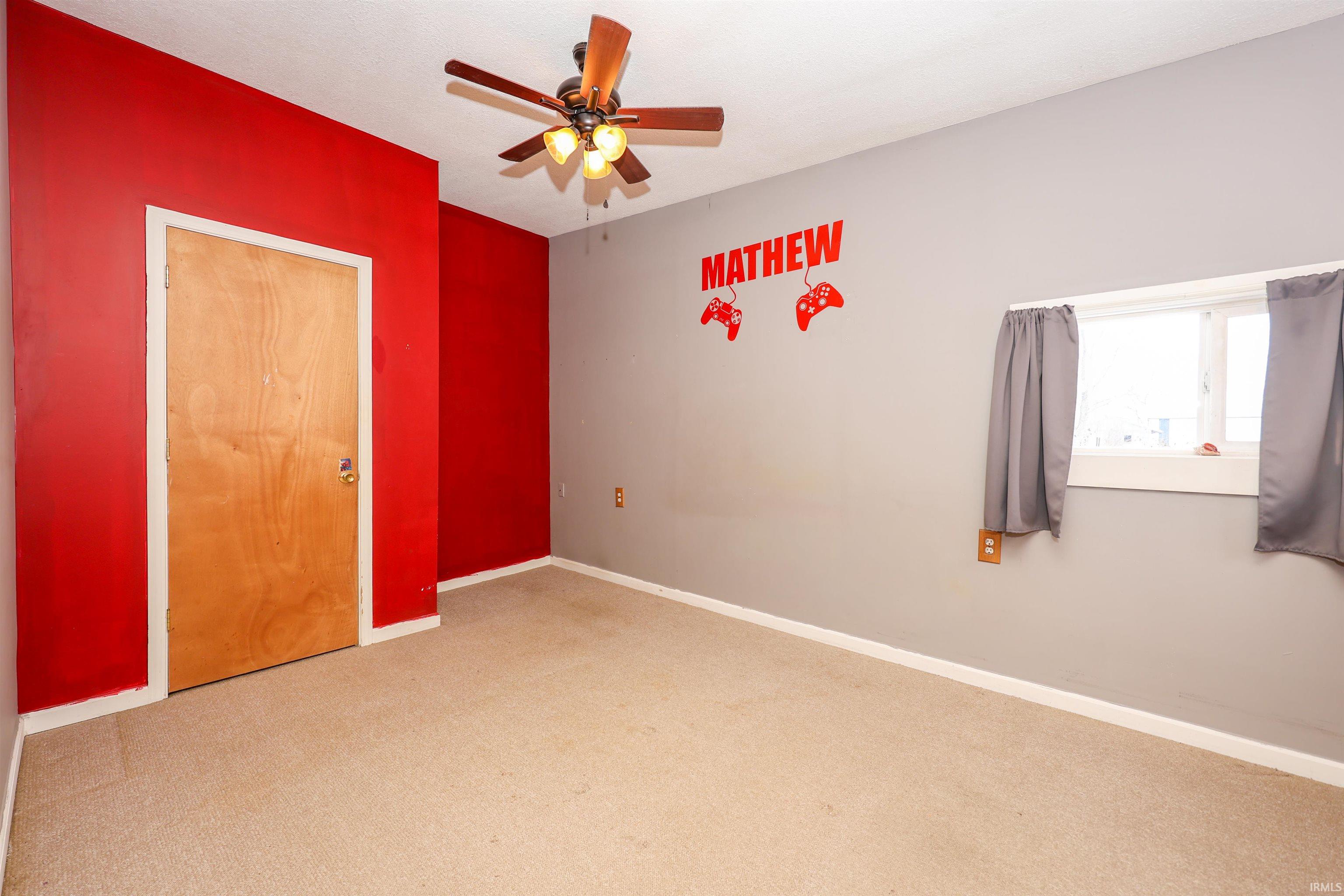 Unfurnished bedroom with a ceiling fan and carpet flooring