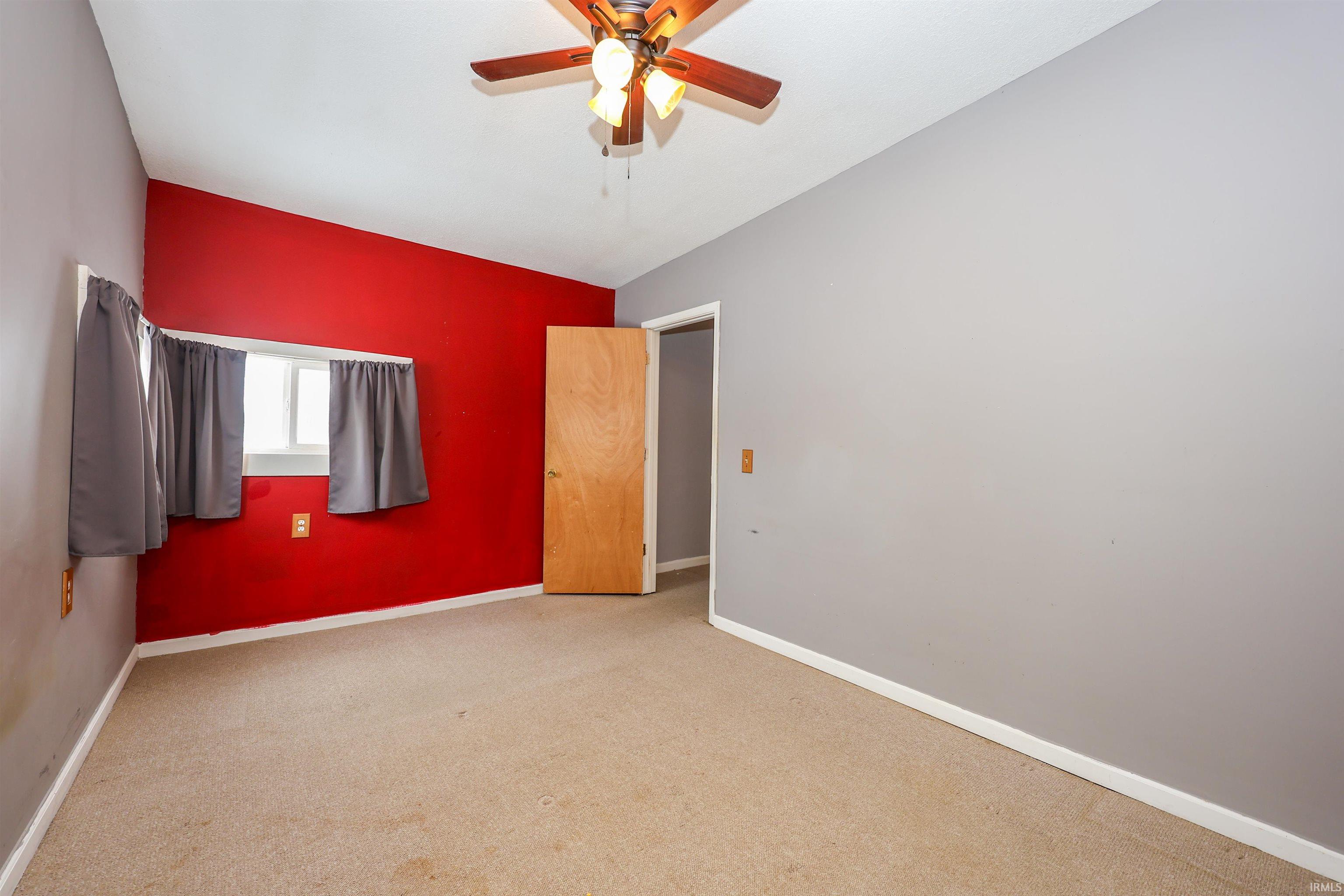 Unfurnished bedroom featuring carpet and ceiling fan