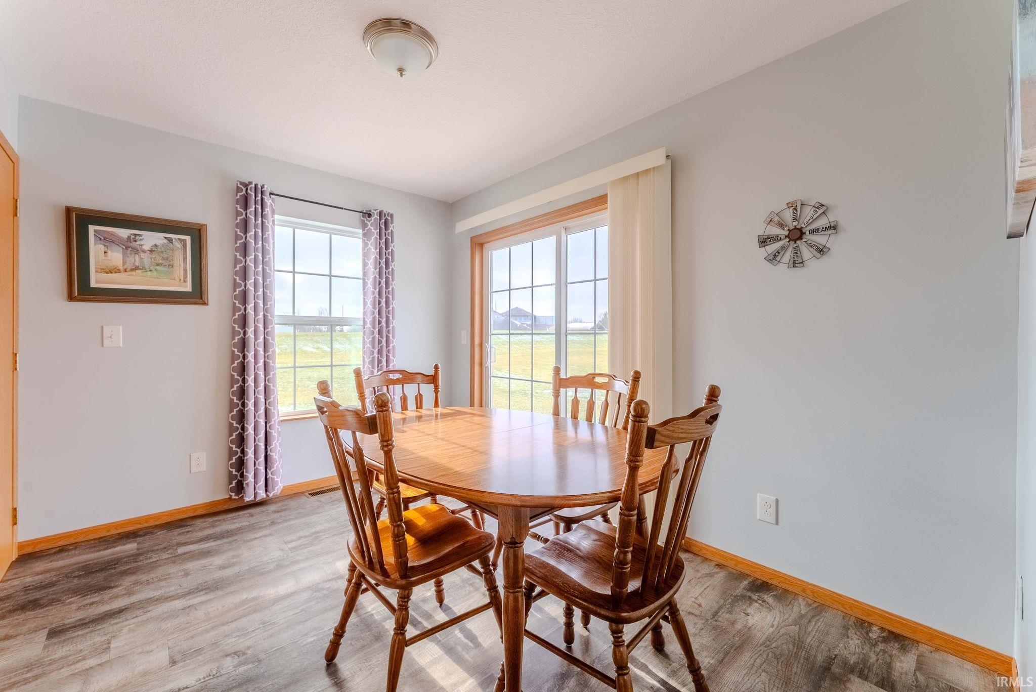 Dining area with light wood-type flooring and baseboards