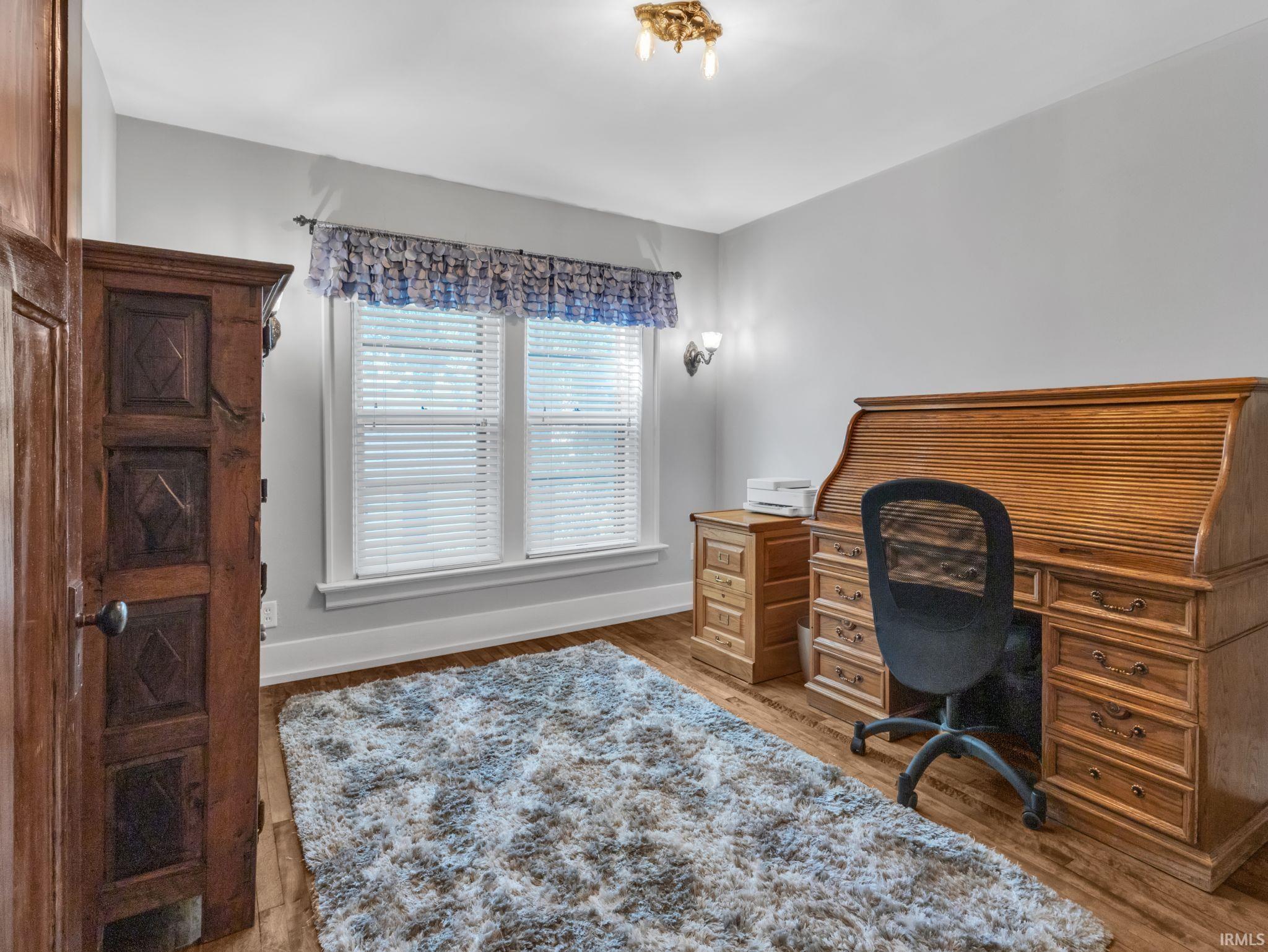 Office area featuring light wood-style floors and baseboards