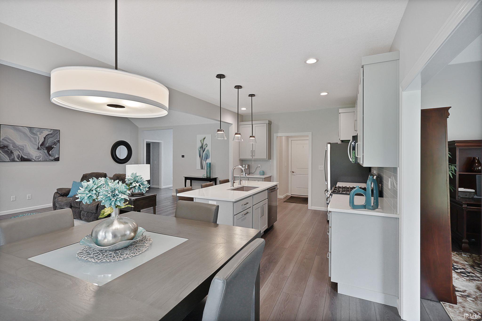 Dining room with dark wood finished floors and recessed lighting
