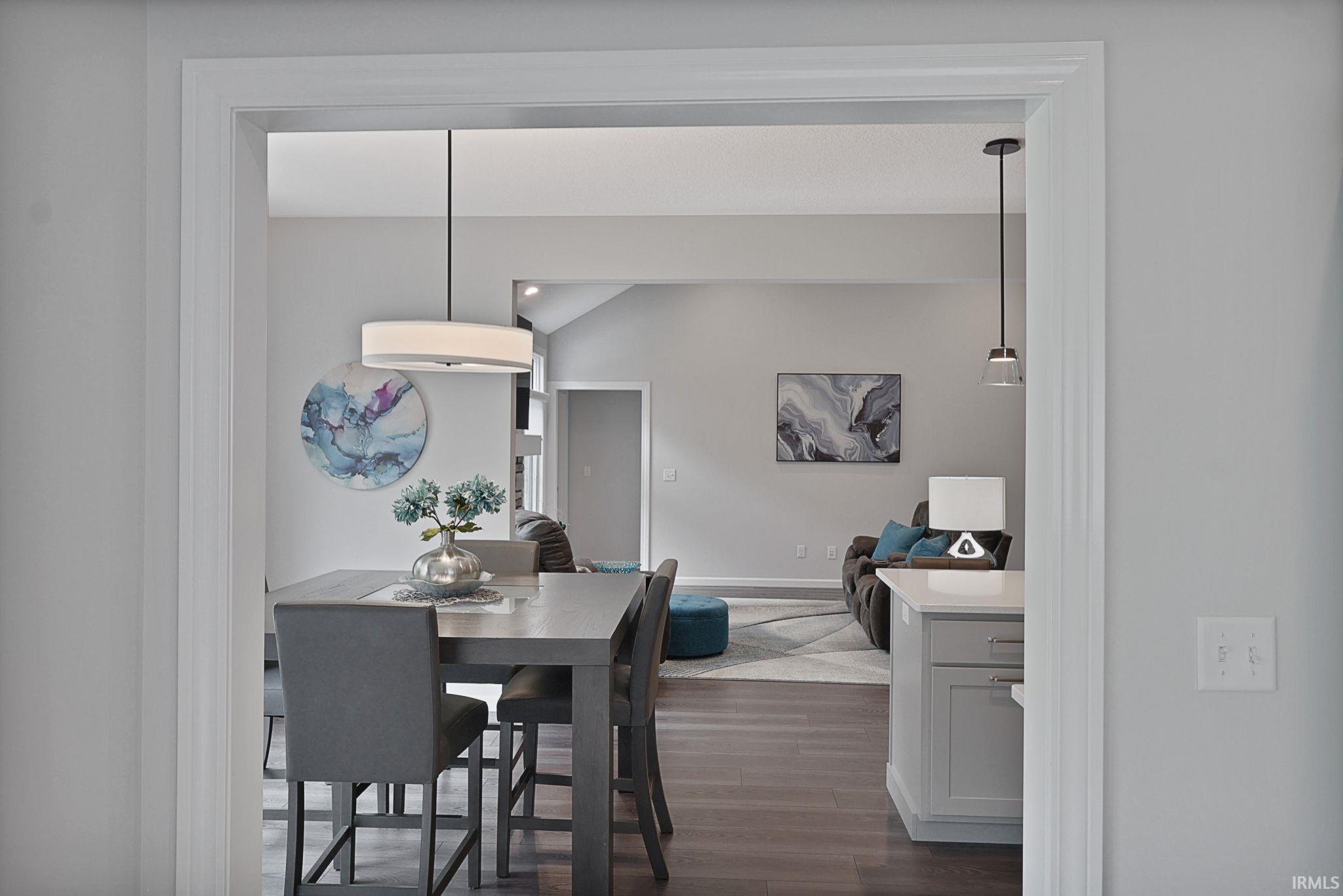 Dining room featuring dark wood-style flooring and baseboards