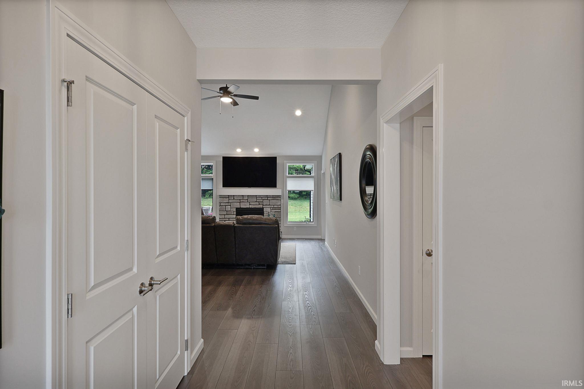 Hallway featuring dark wood-type flooring and recessed lighting