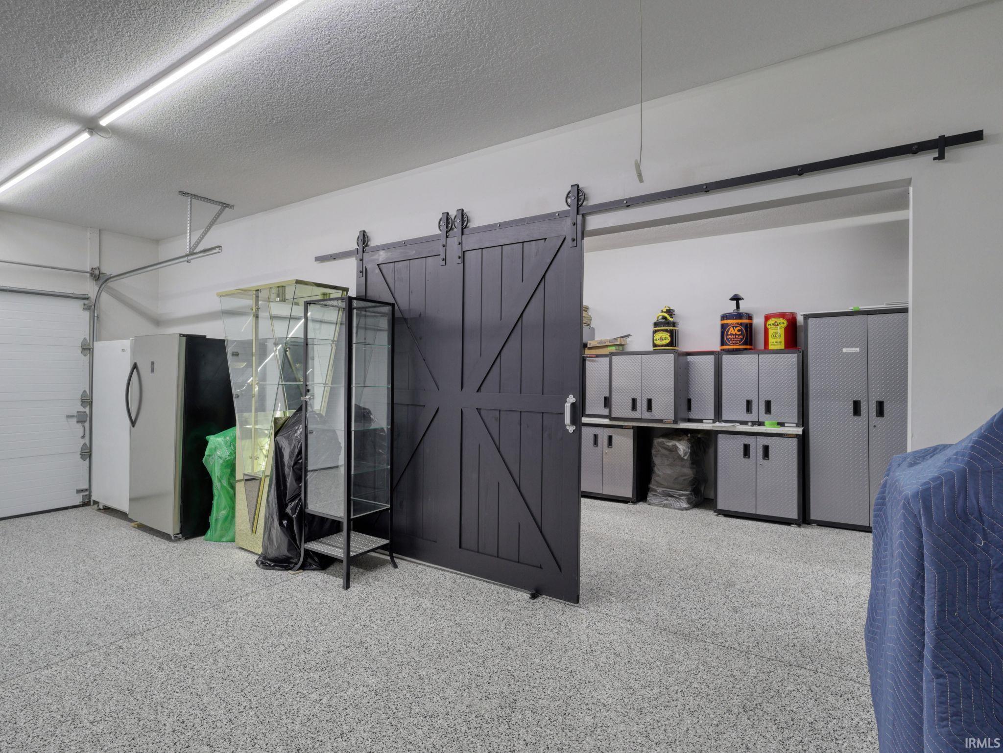 Garage featuring freestanding refrigerator