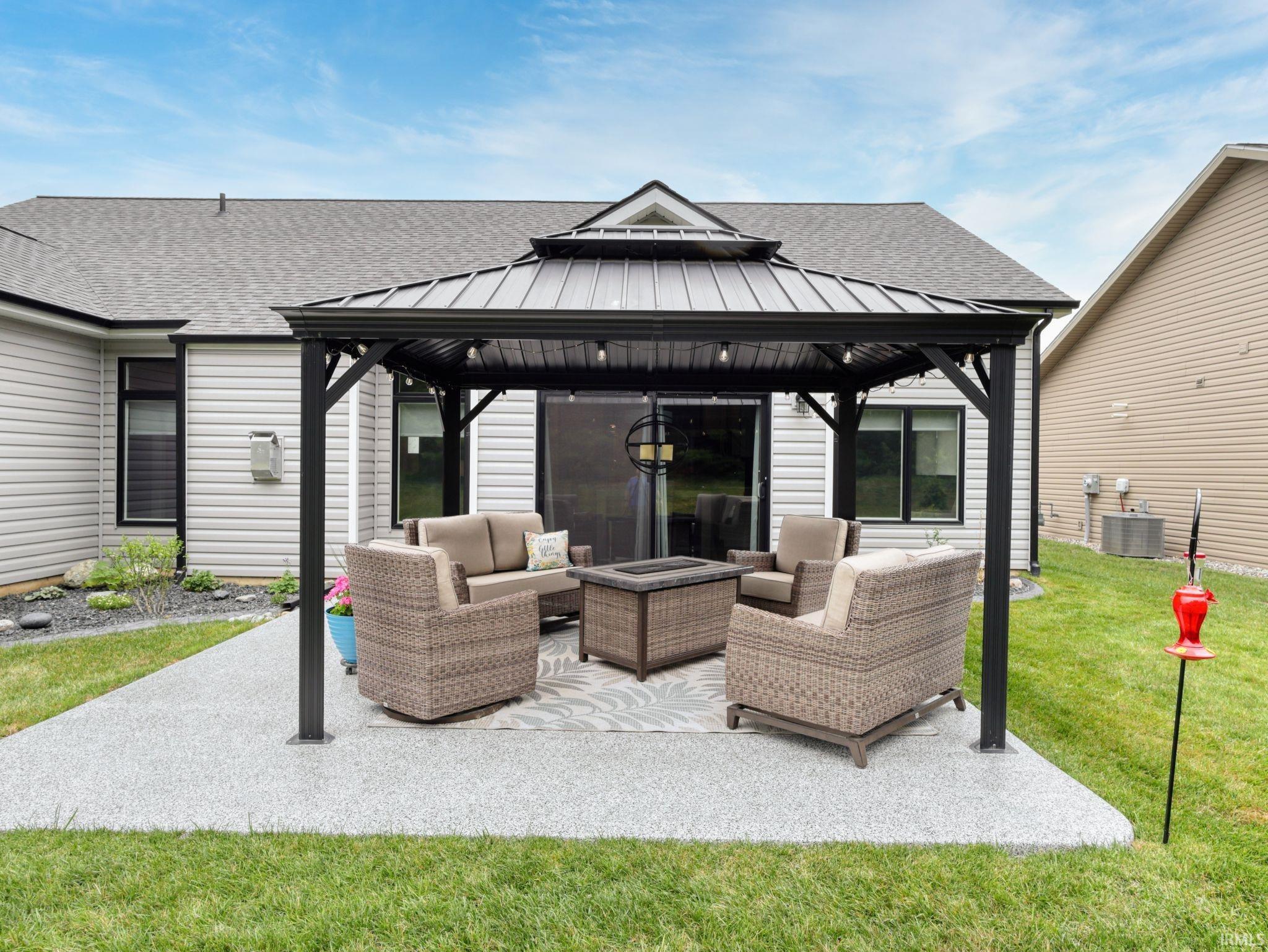 View of patio featuring a gazebo and an outdoor hangout area