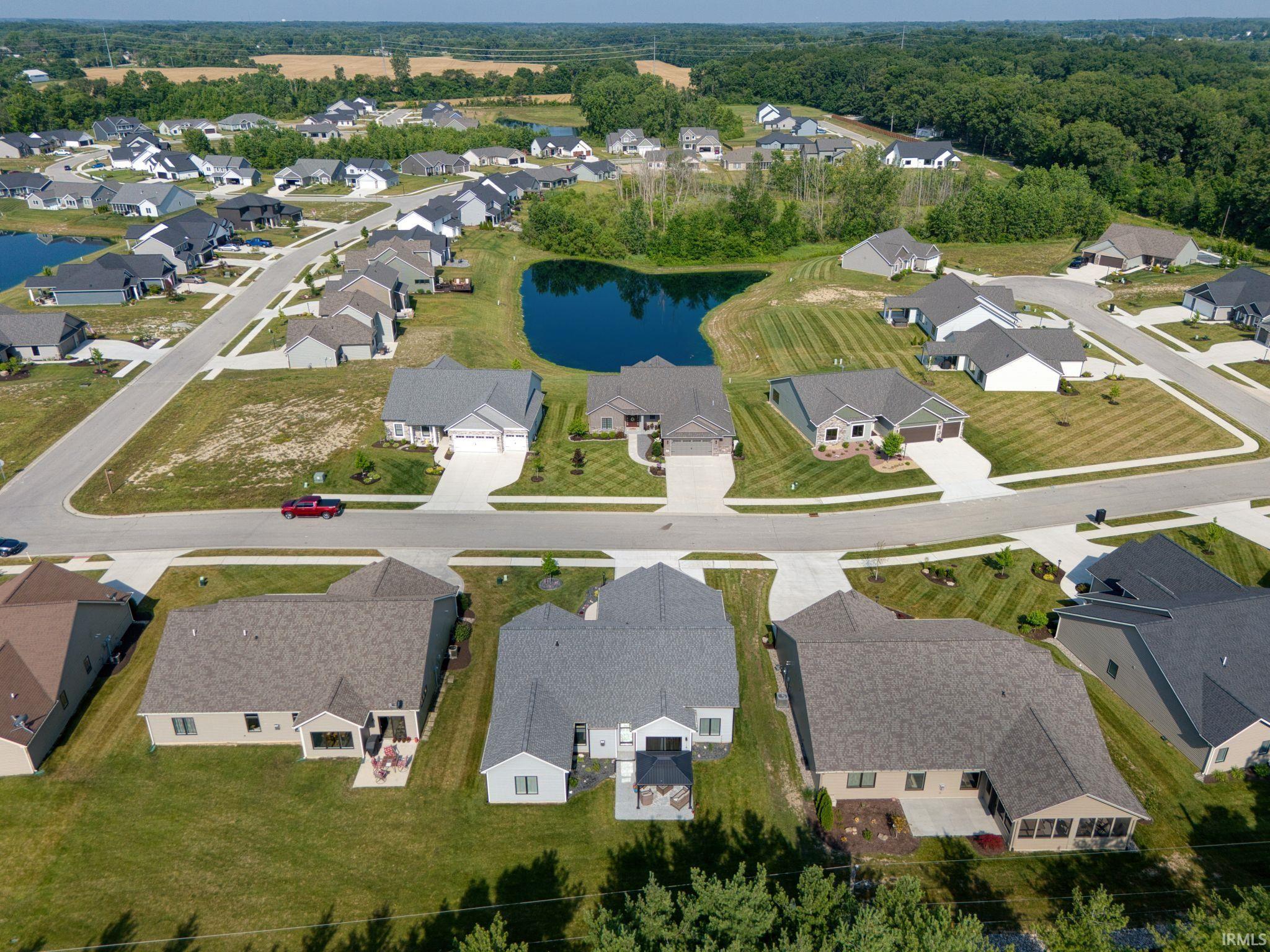 Aerial overview of property's location with nearby suburban area and a large body of water